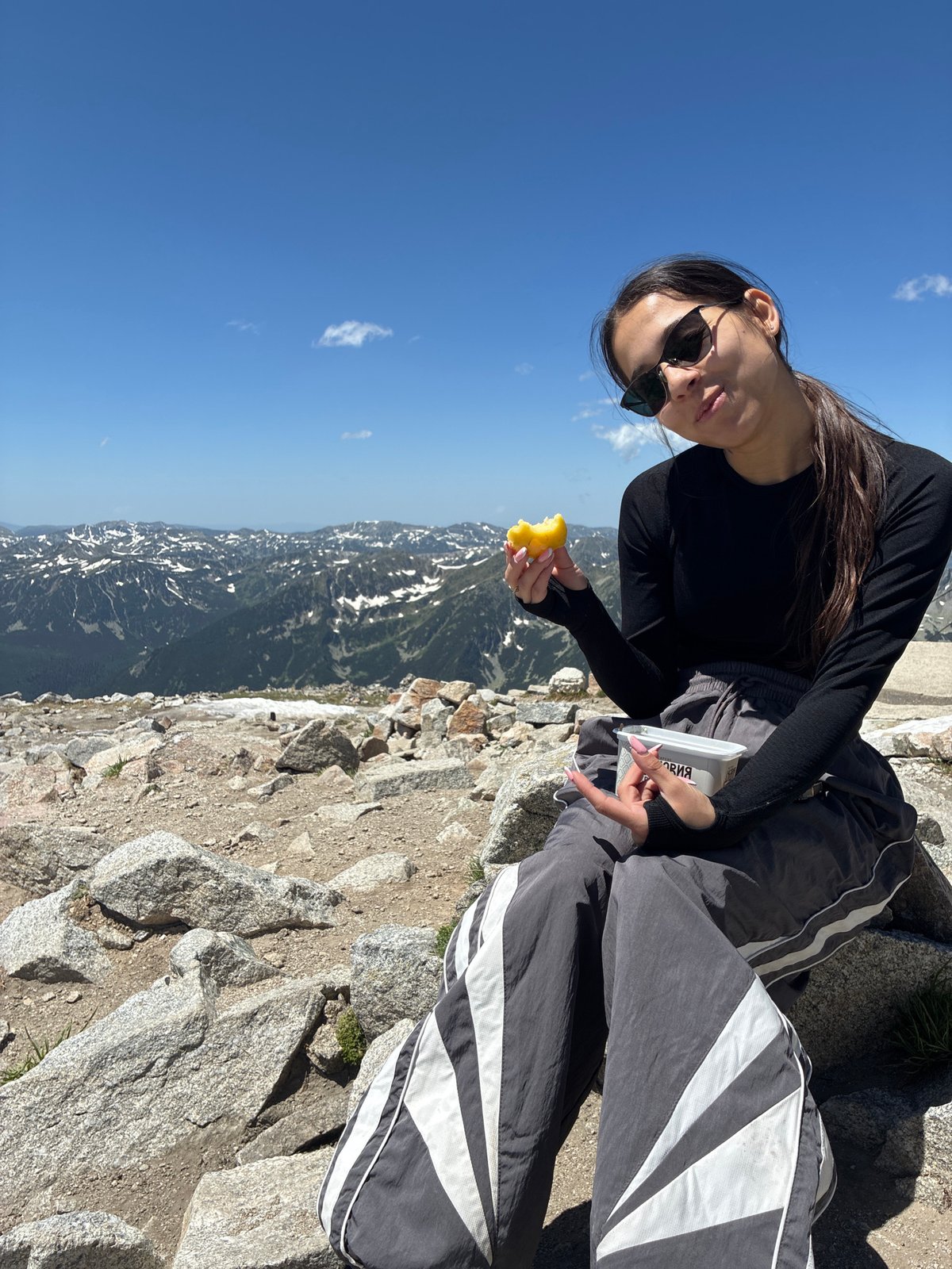 Snack break and summit views at Musala Peak, Rila Mountains
