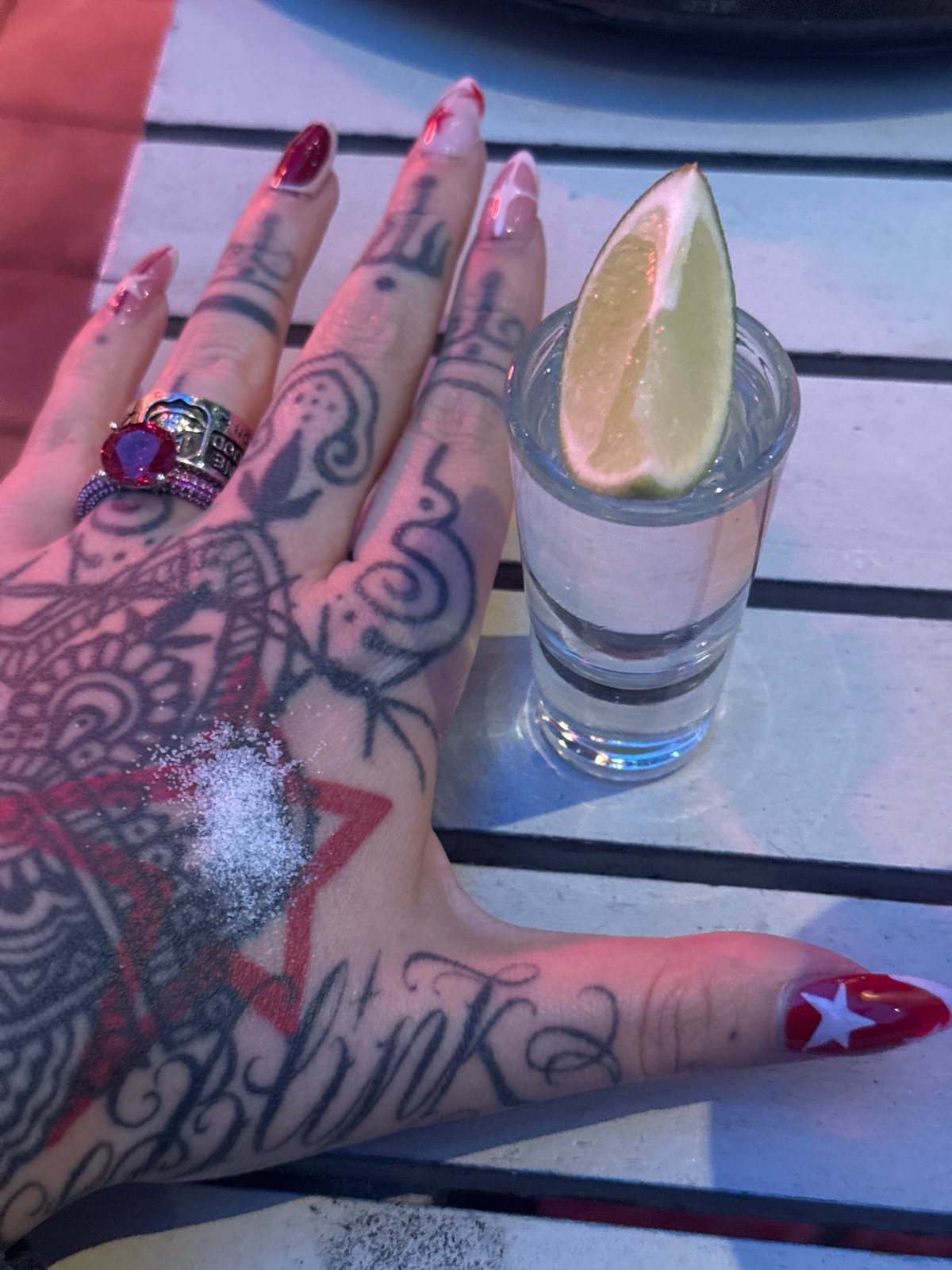 Group toasts with shots outdoors in London evening gathering