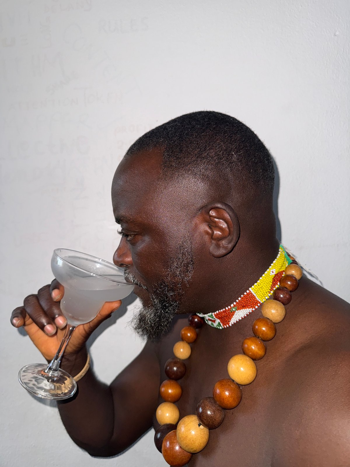 Man drinks from glass in Ado, Nigeria