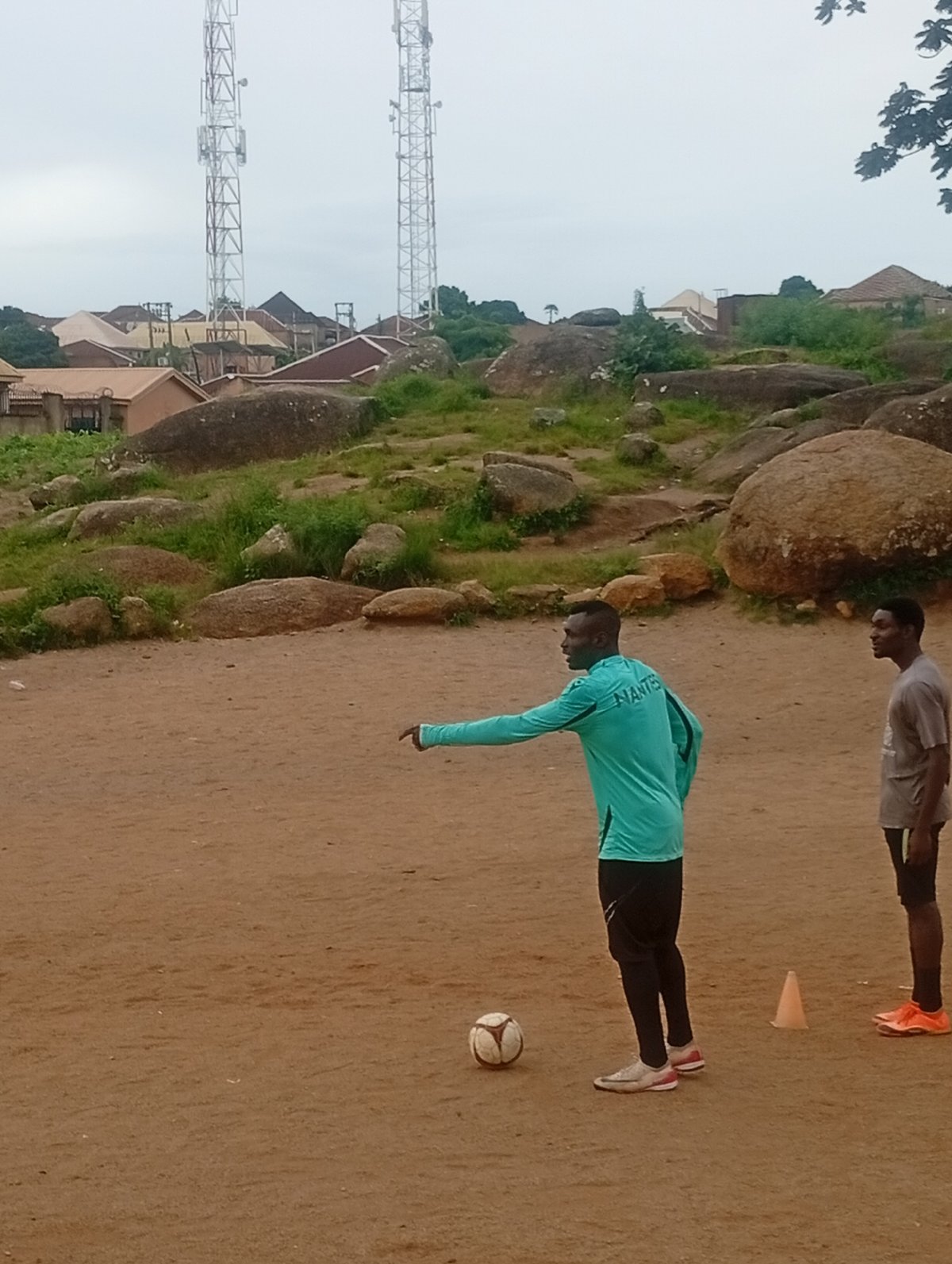 Pickup football training on a rocky dirt pitch in Jos, Nigeria