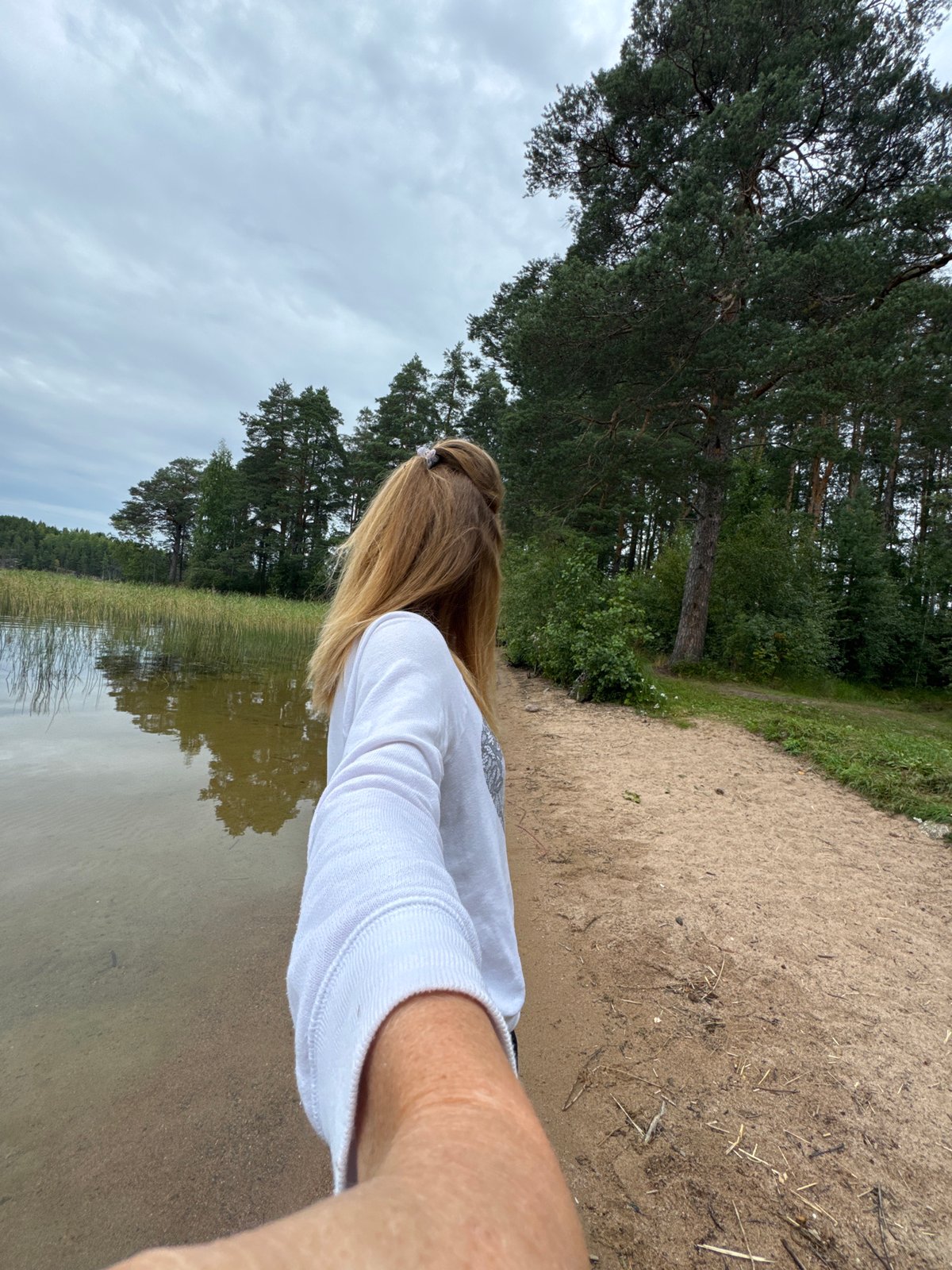 Calm afternoon at a clear, pebbly lake in Kulikovo