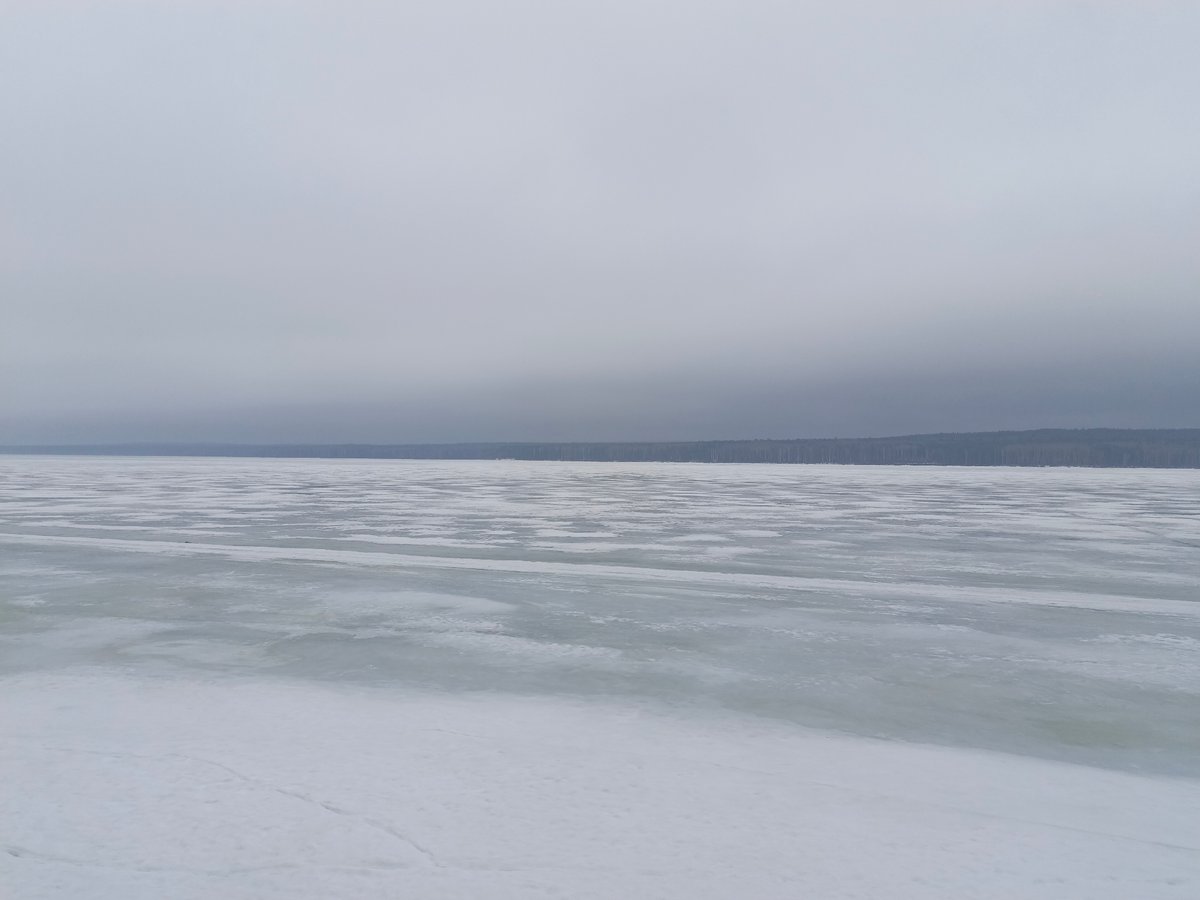 Man visits chess tables at frozen lakeside park in Russia
