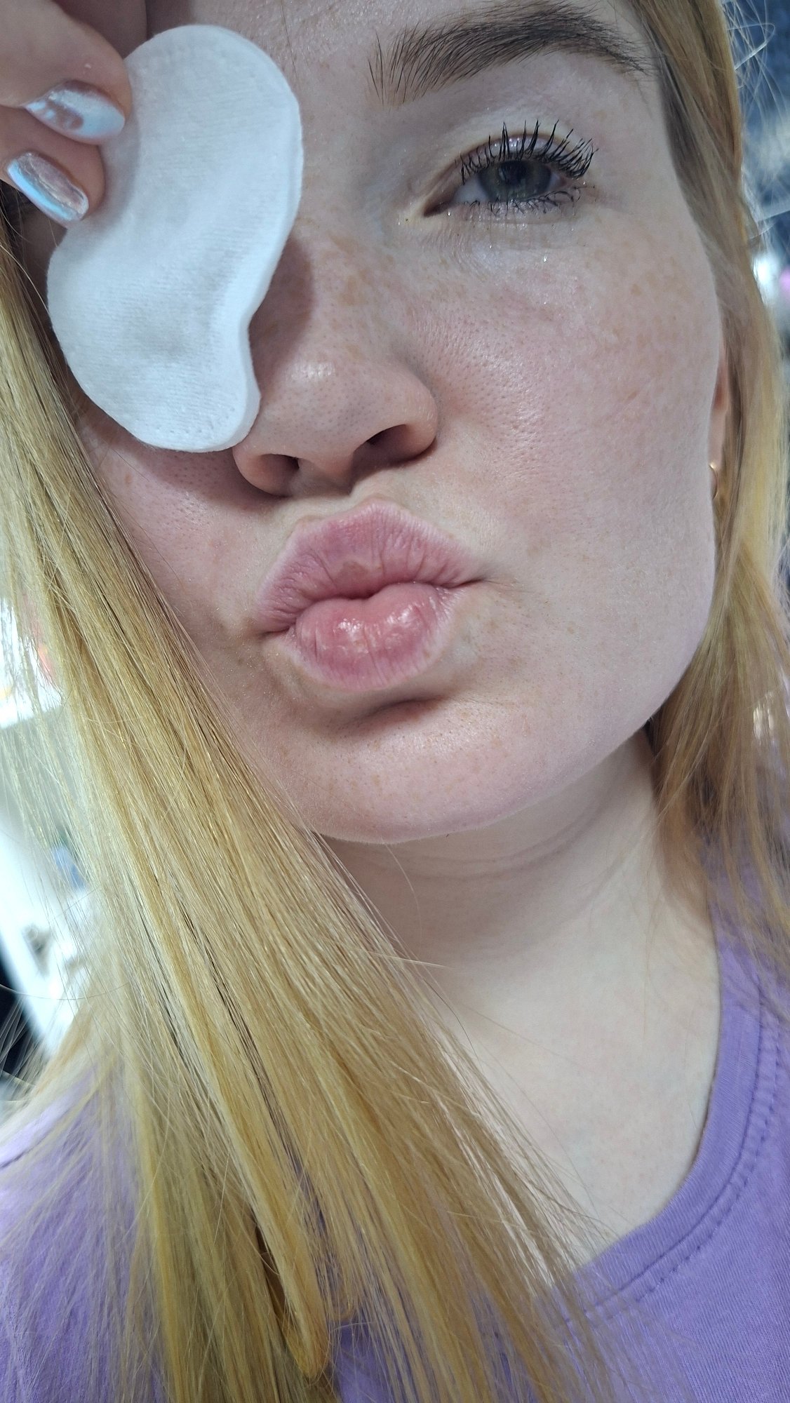 Woman removes makeup with cotton pads in Chaikovsky