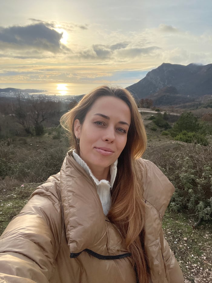 Tourists photograph sunset mountain scenery in Montenegro