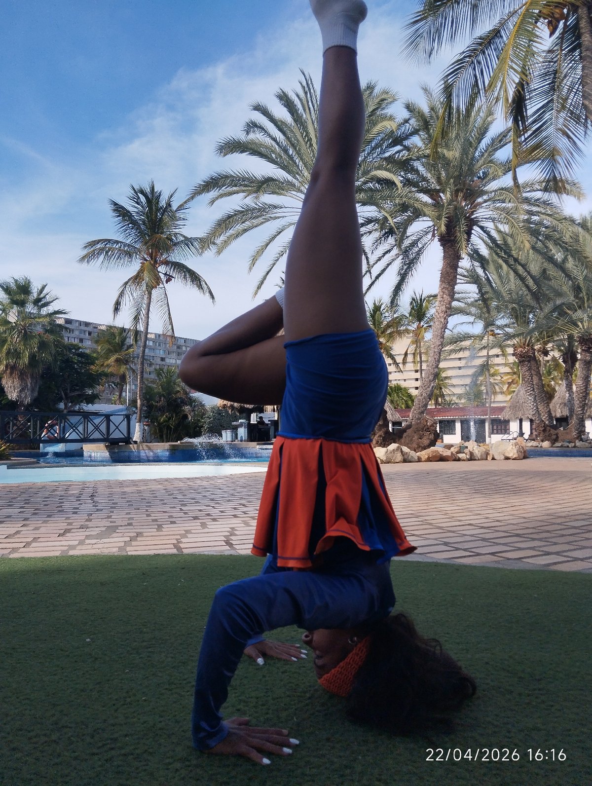 Person performs acrobatic handstands and backbends on artificial turf
