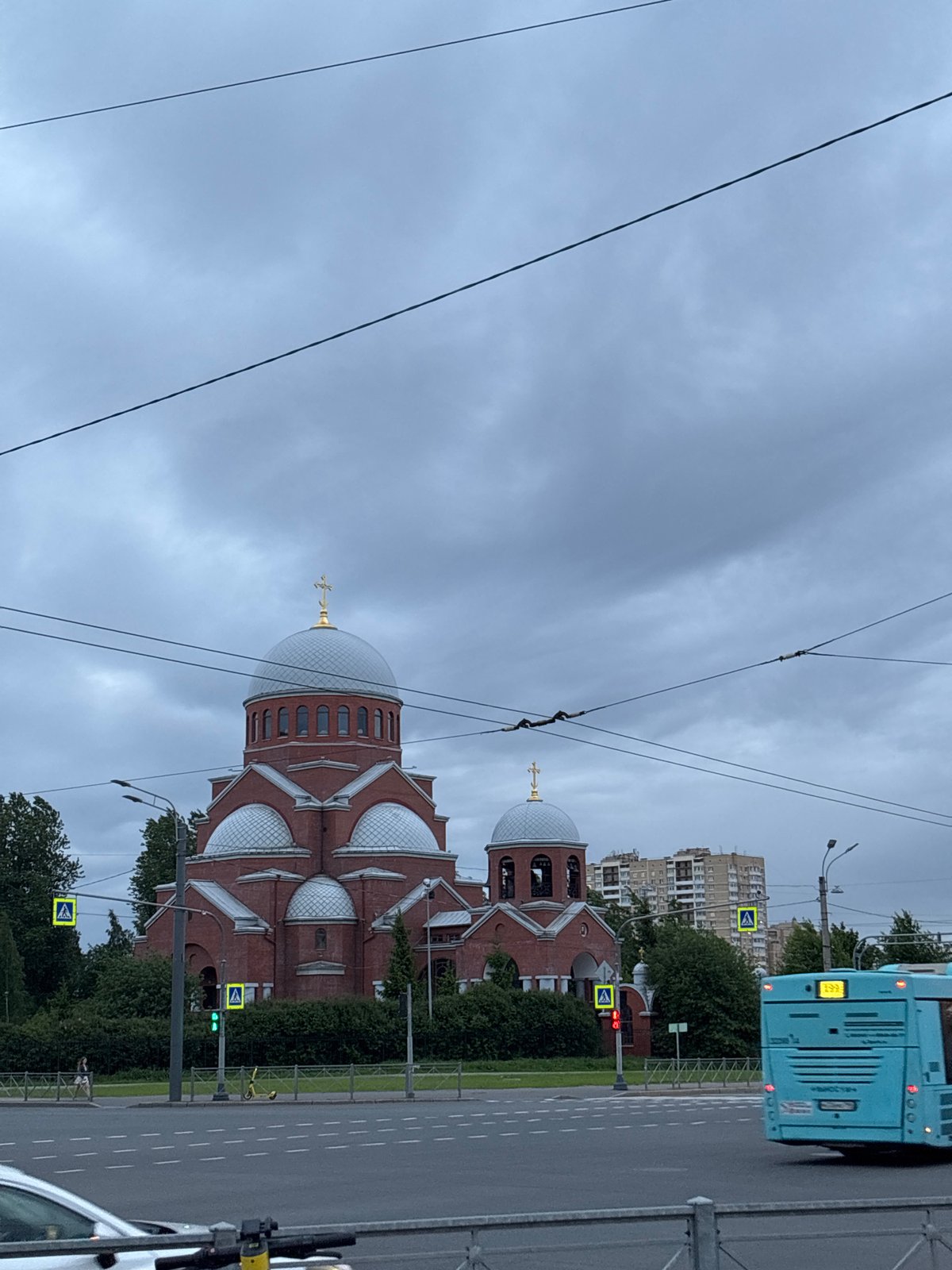 Woman takes selfie near domed church in urban setting