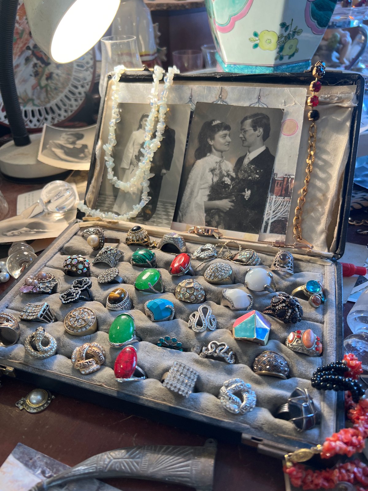 Open jewelry box with assorted accessories documented by witness
