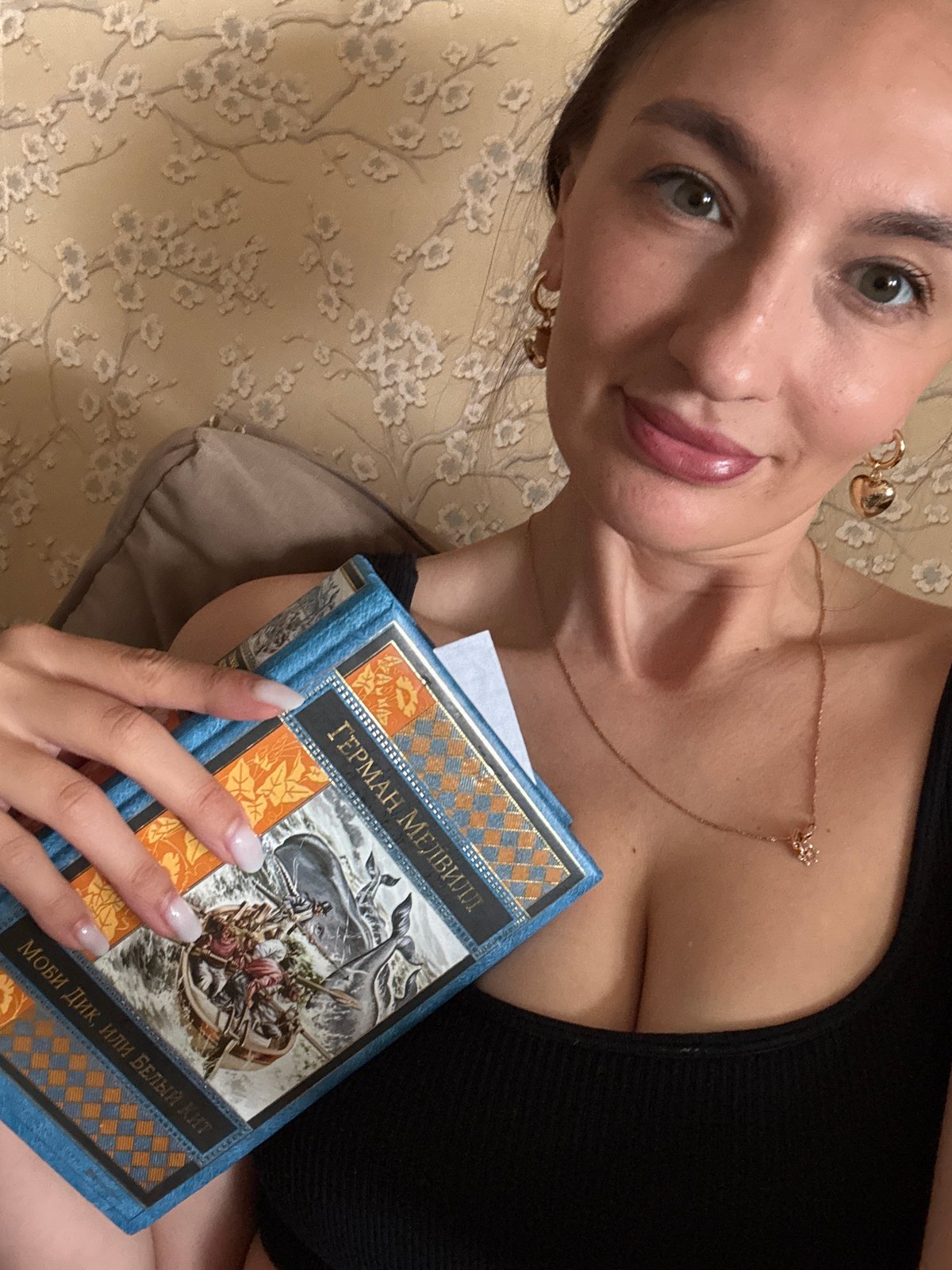 Woman in Sochi reads, snacks, takes selfie during afternoon