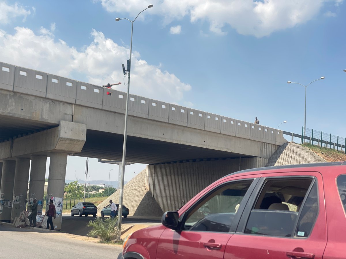 Daytime traffic scene documented at Abuja overpass intersection