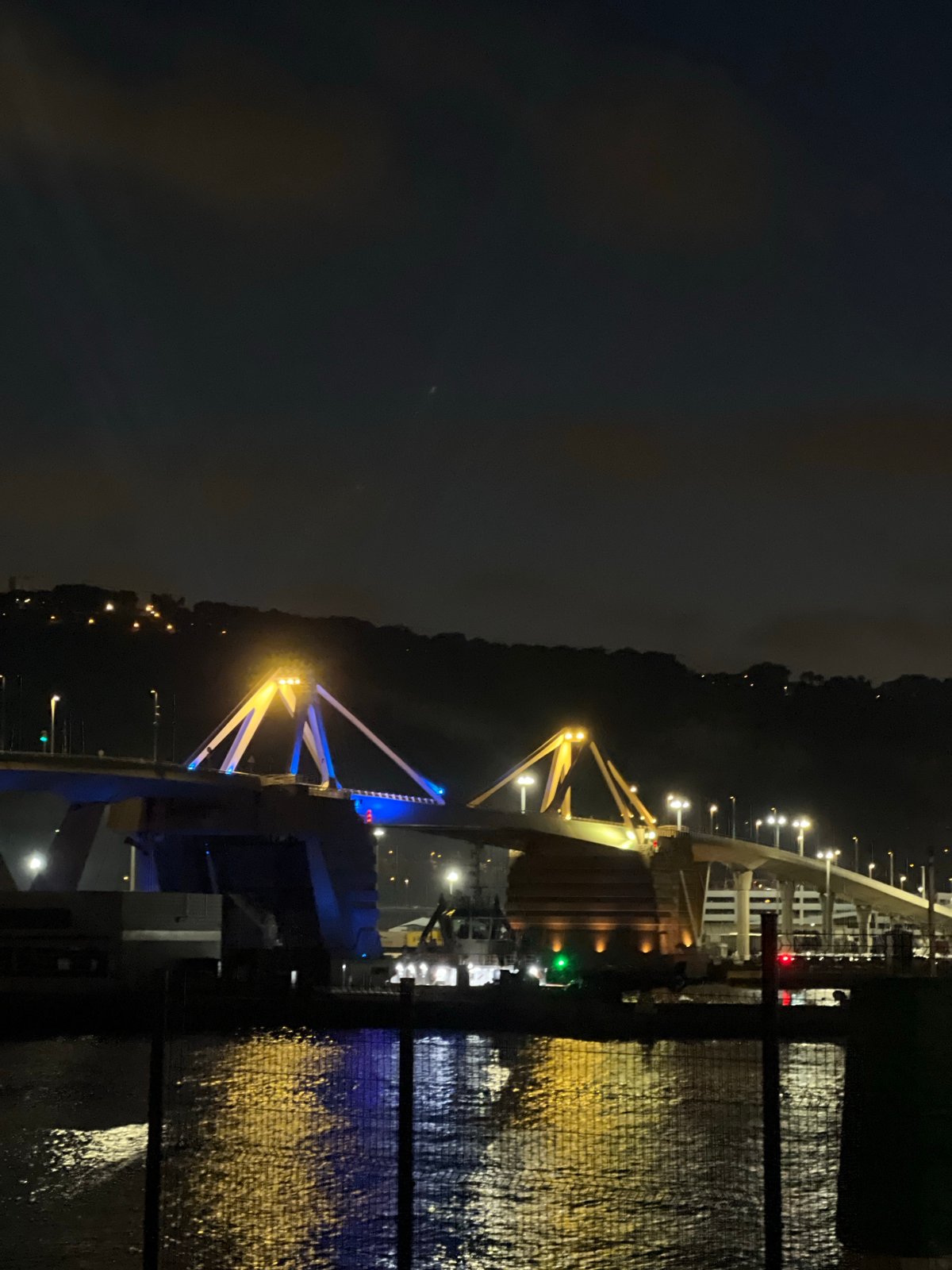 Barcelona's Bac de Roda bridge glows under crescent moon