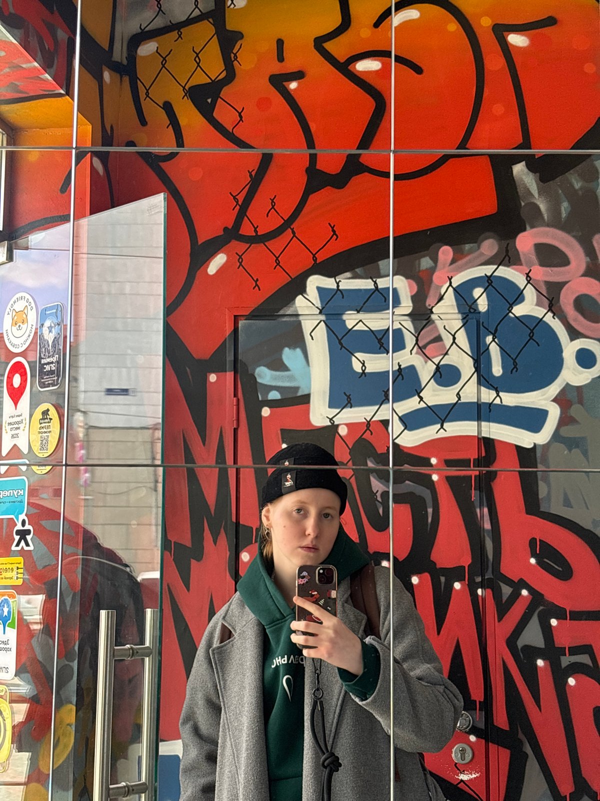 Young person documents street art scene in Perm cafe