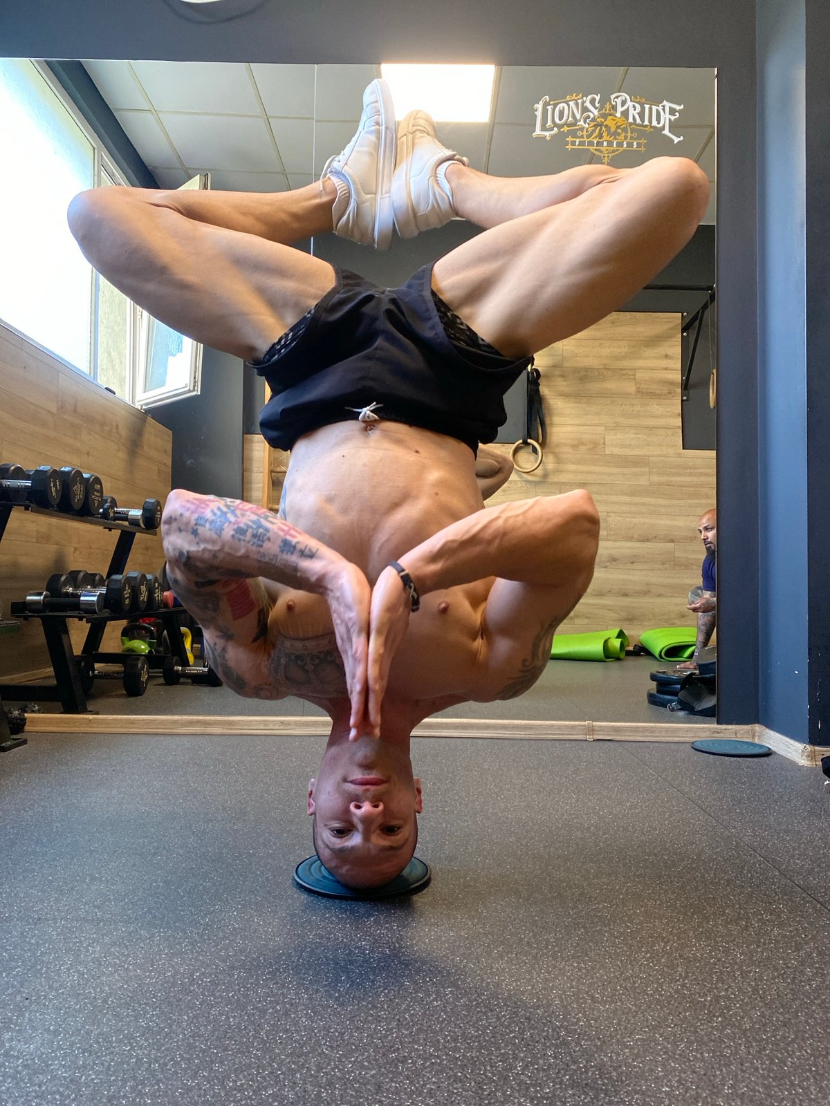 Man performs headstand exercise at Pleven gym