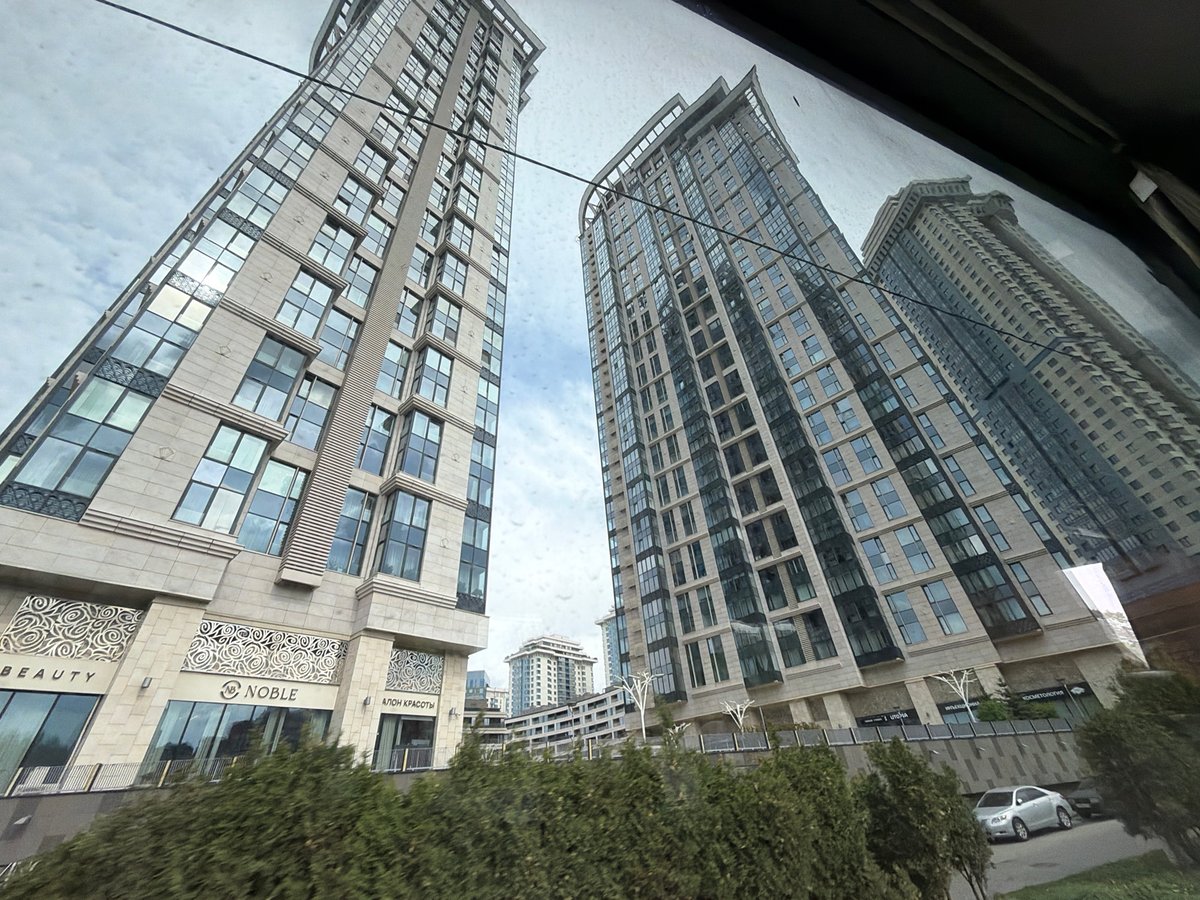 Building reflections captured in Moscow window show commercial signage