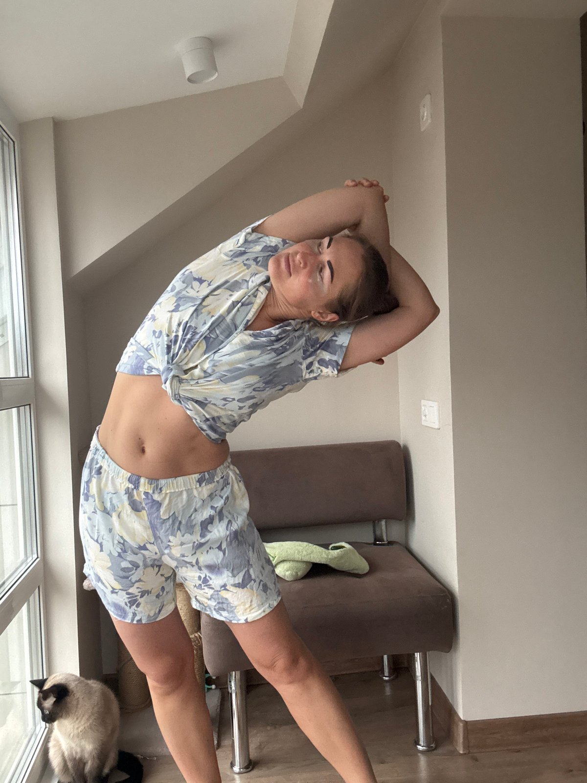 Woman in pajamas photographed indoors in Chaikovsky, Russia
