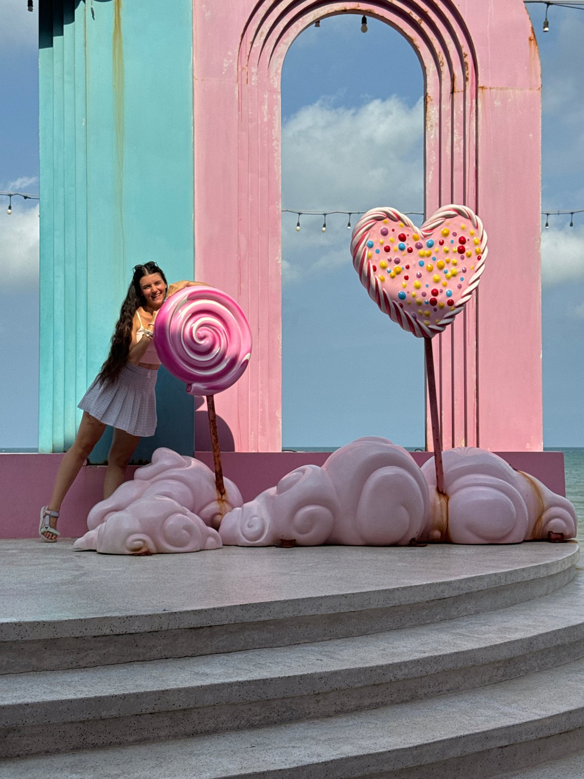 Woman poses at whimsical Pinky Garden candy installation in Vietnam