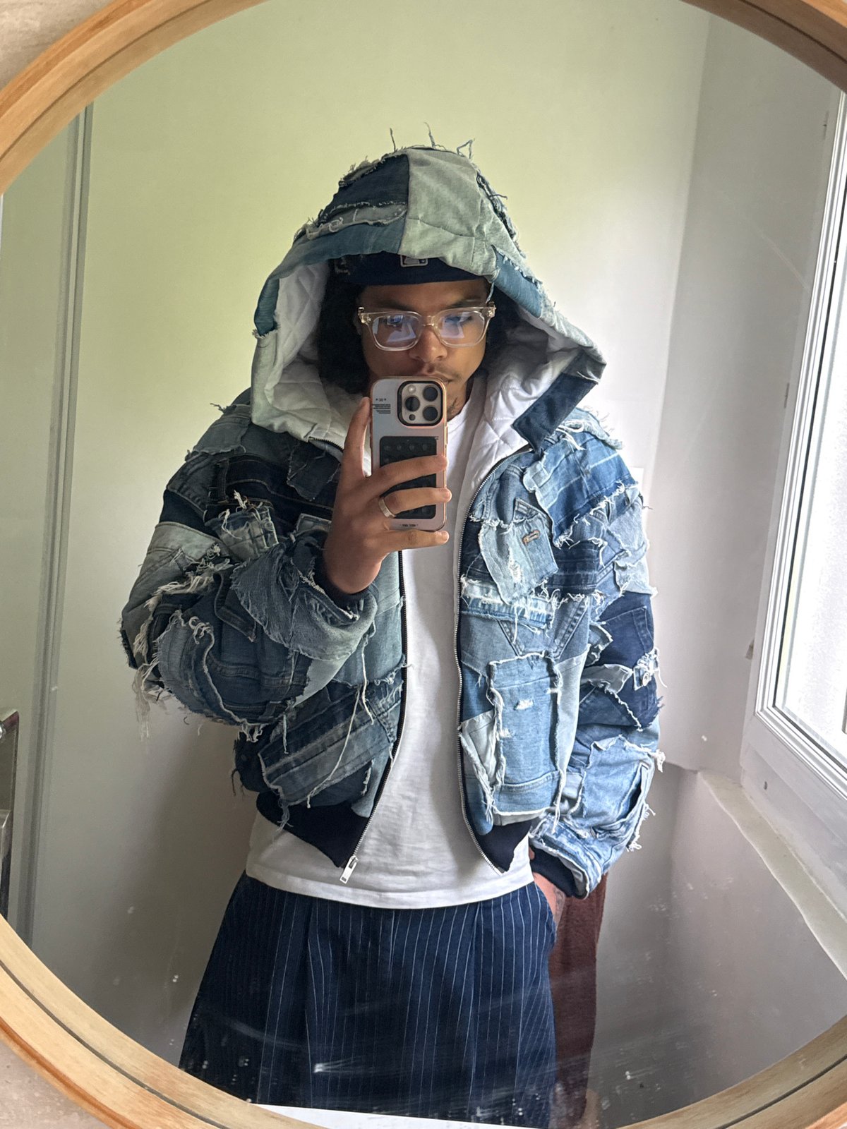 Person takes mirror selfies in distinctive denim jacket, Massy