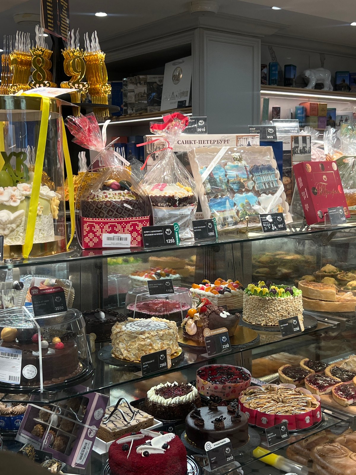 Bakery display case showcased assorted cakes and pastries in Saint Petersburg