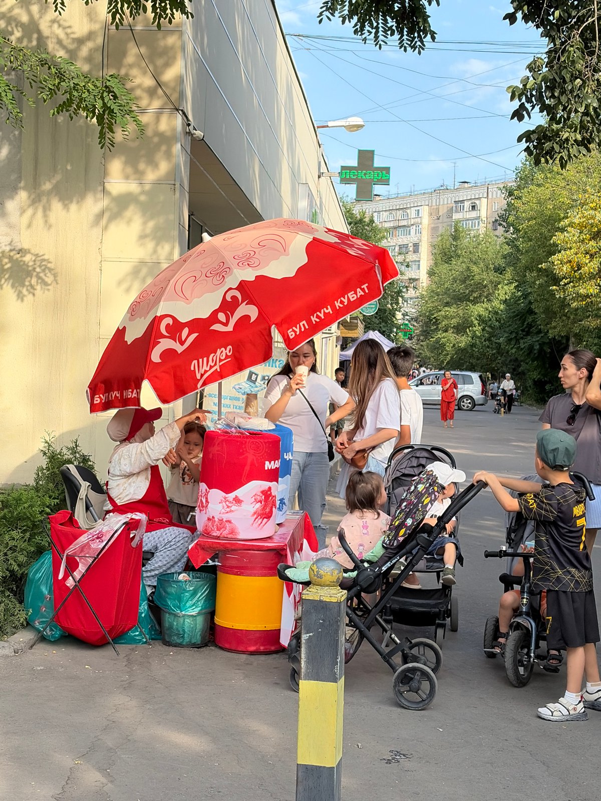 Street vendors, cyclists, and park visitors during midday hours