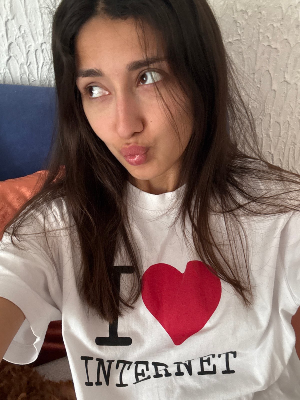 Woman in Internet-themed shirt photographed lying down in Montenegro
