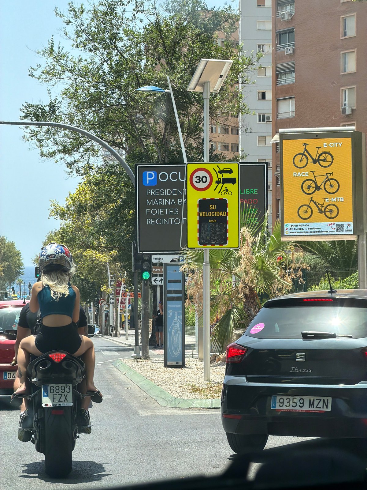 Midday traffic and street life in sunny Benidorm