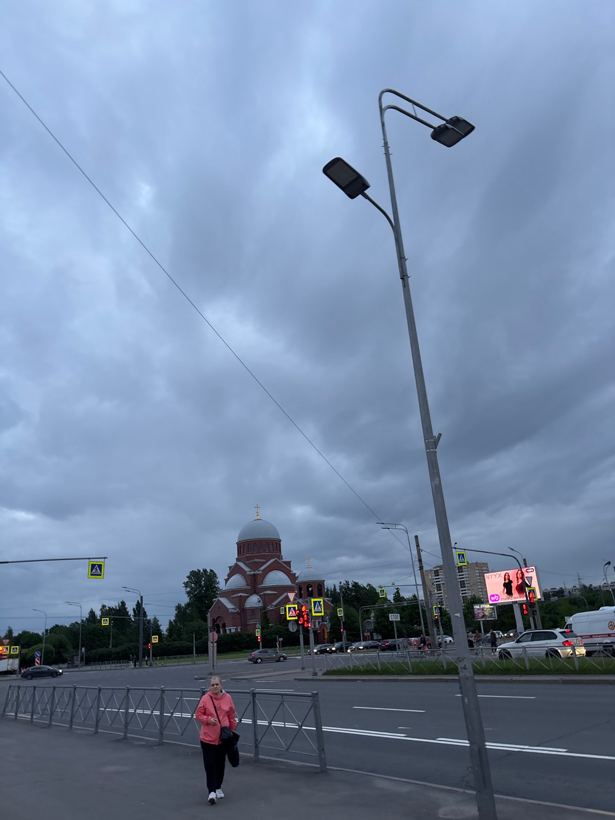 Woman photographed walking near Orthodox church and Russian flower shop