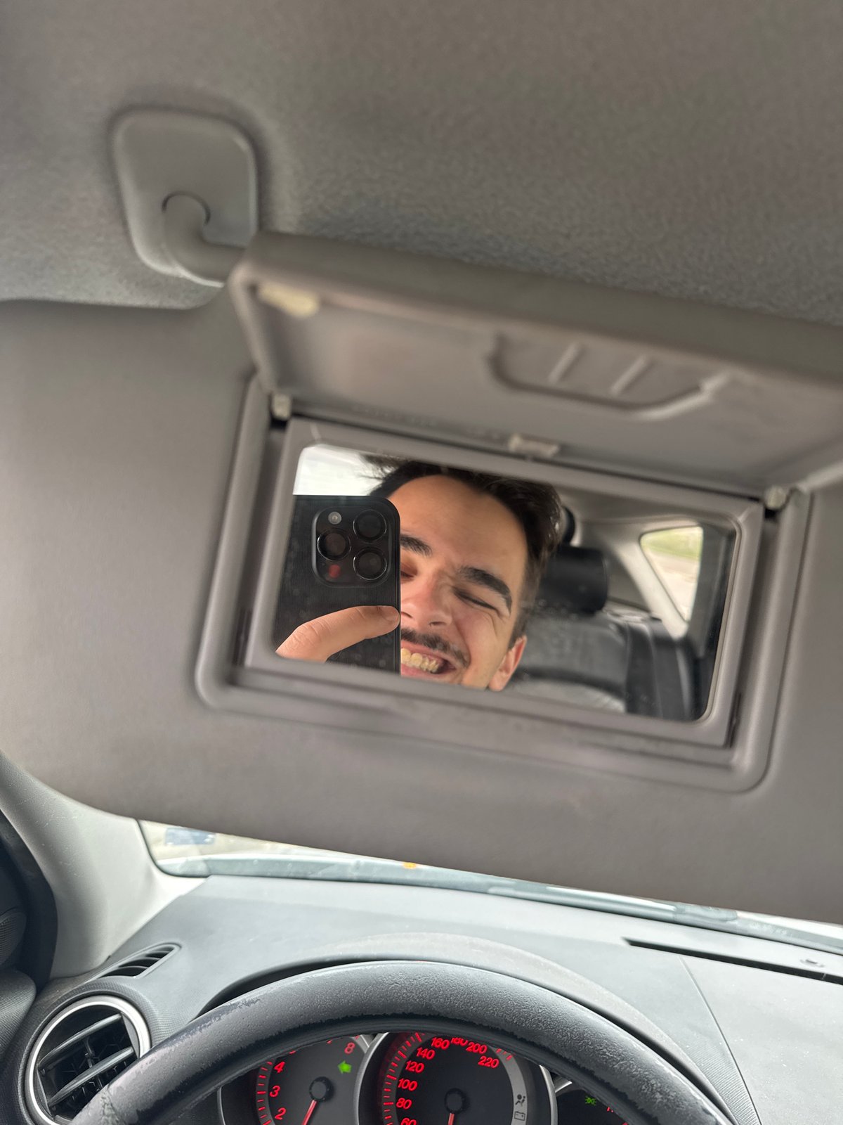 Driver takes selfie using sun visor mirror in Sofia