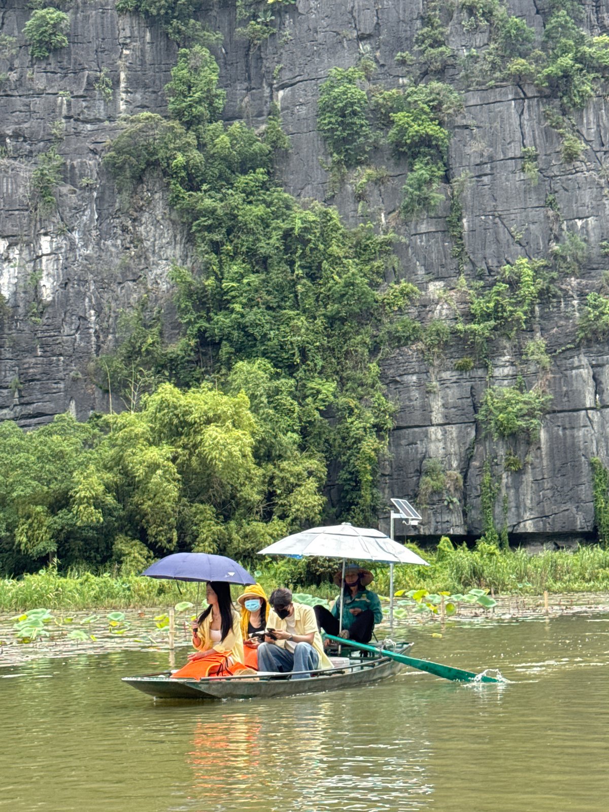 Boat tour through limestone karst waterways in Ninh Bình