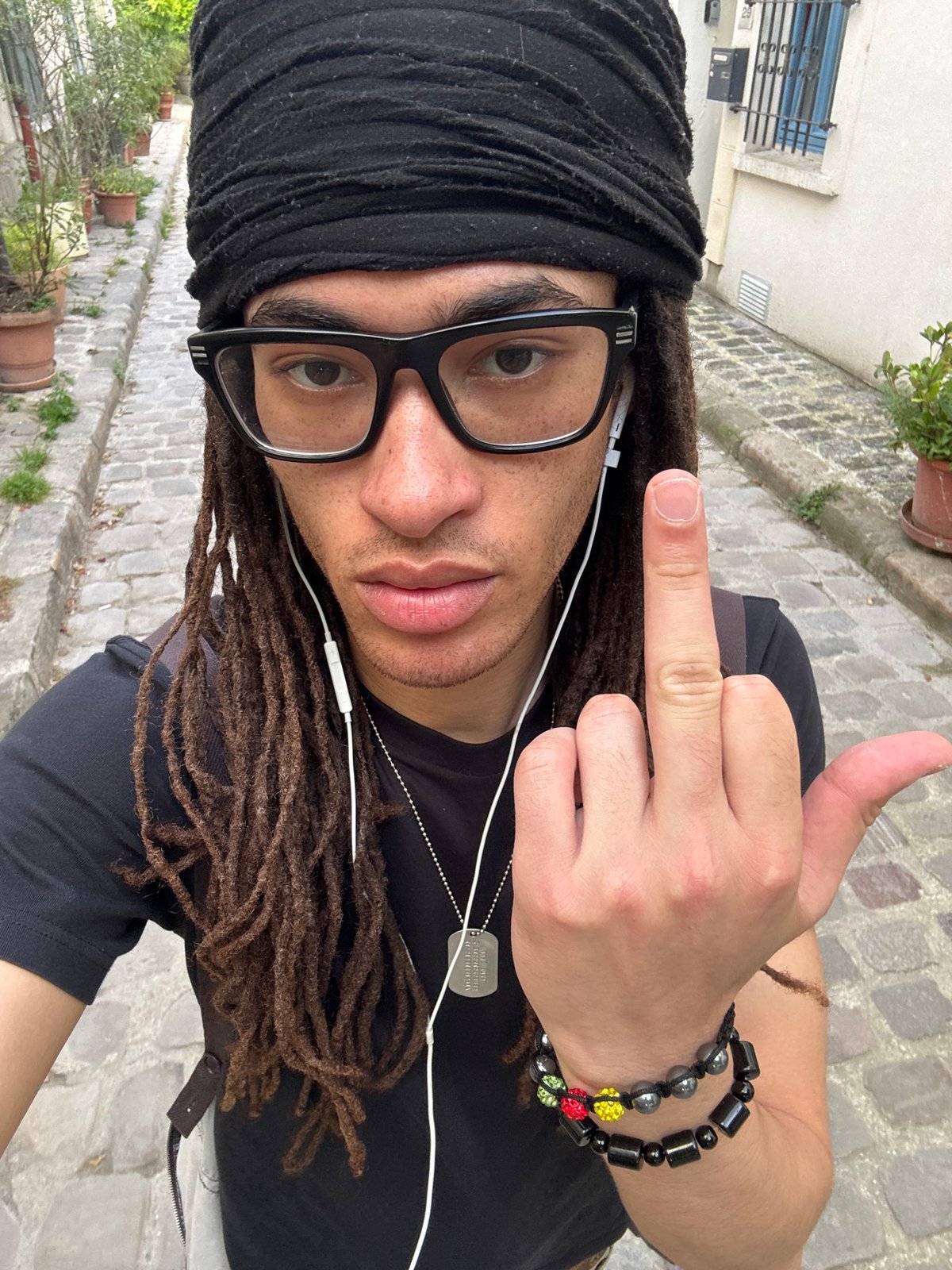 Person in black head wrap photographed in Paris