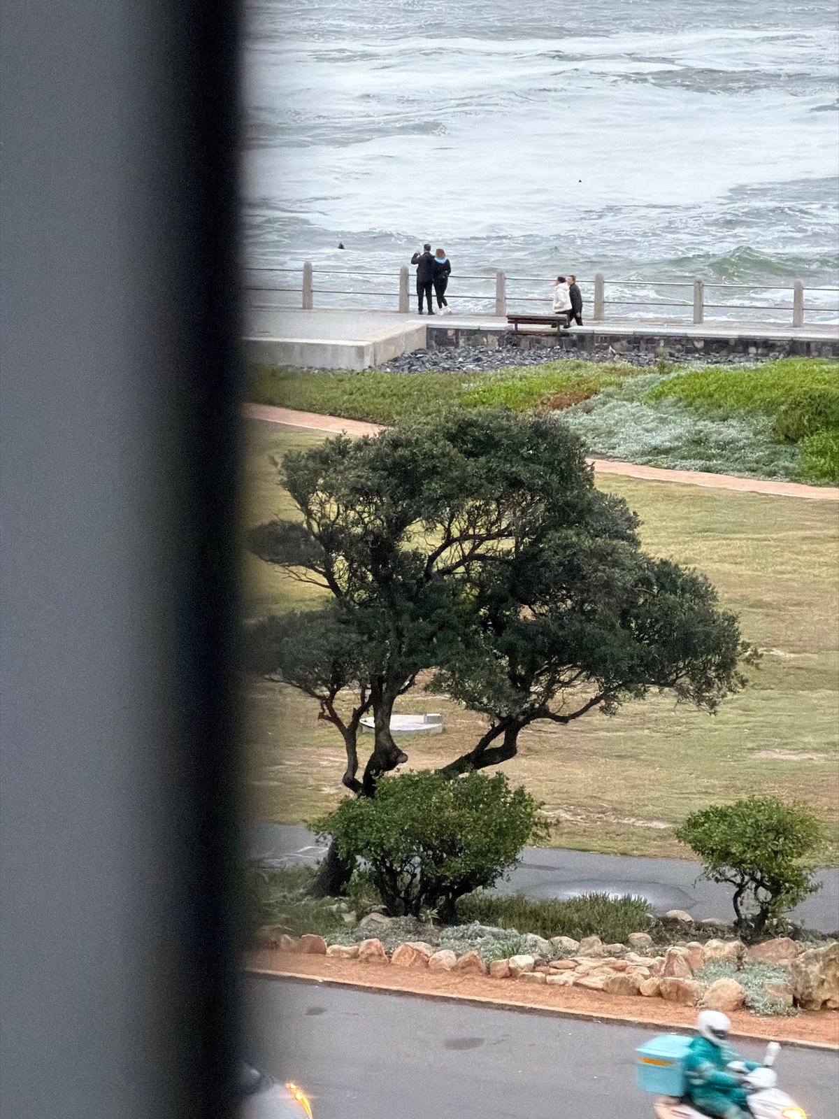 Cape Town sunset witnessed from coastal promenade during rough seas