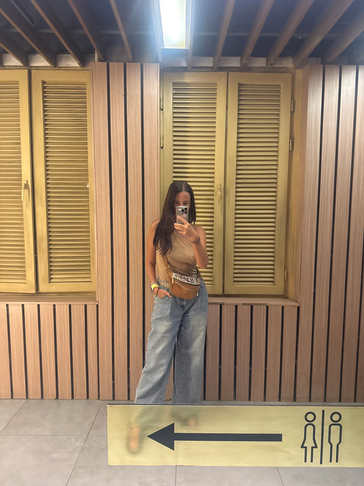 Woman Takes Mirror Selfie in Kuta Selatan Indoor Setting