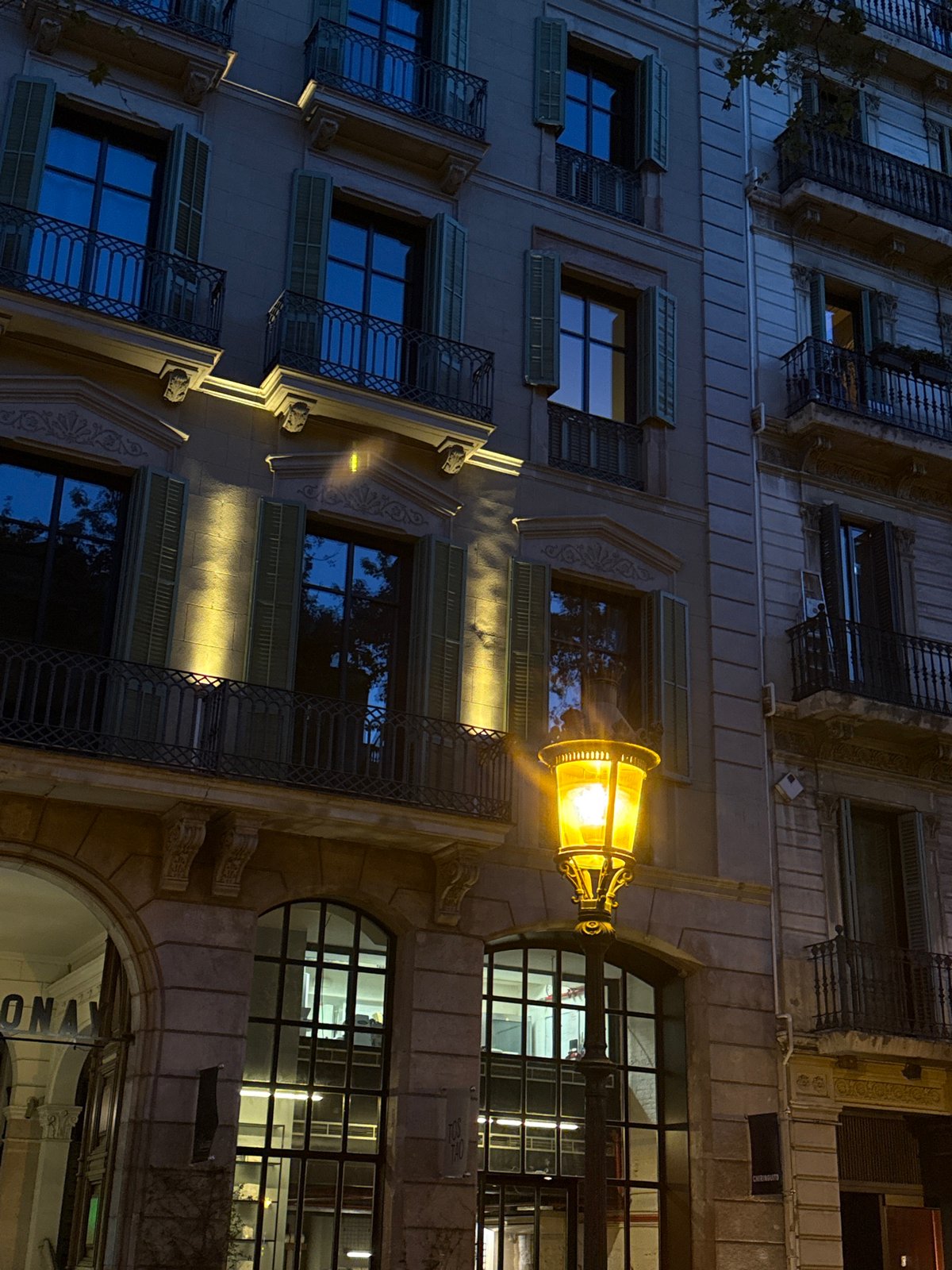 Barcelona building facade documented at night with ornate balconies
