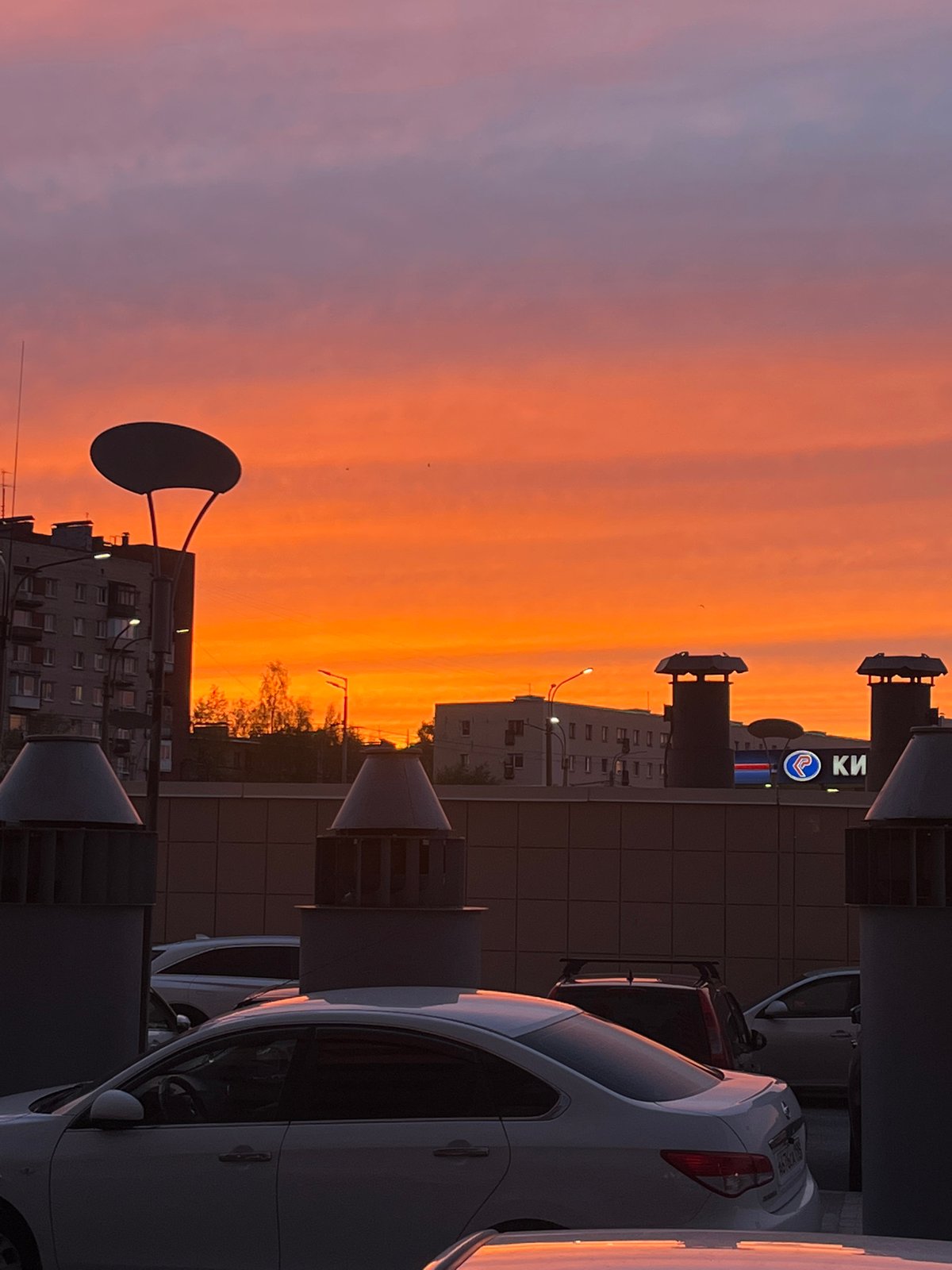 Evening sunset displays orange-pink hues over Saint Petersburg streets
