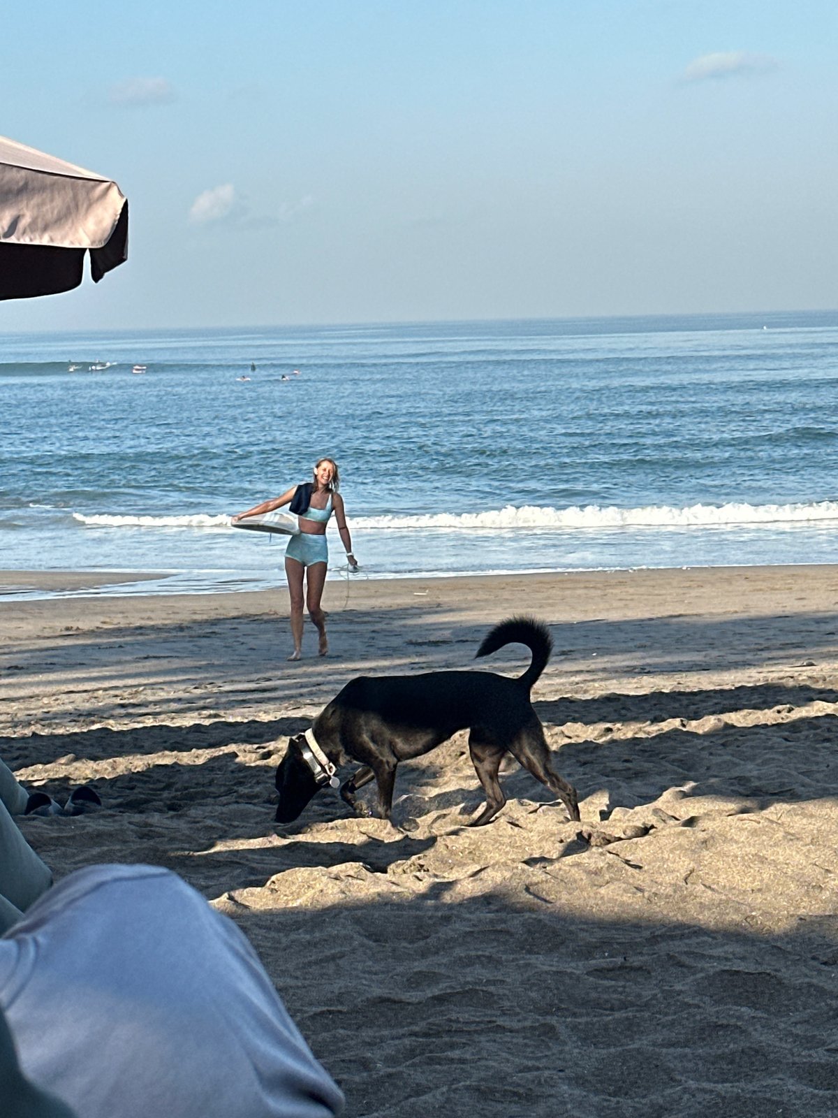 Surfers and beachgoers fill a busy North Kuta morning