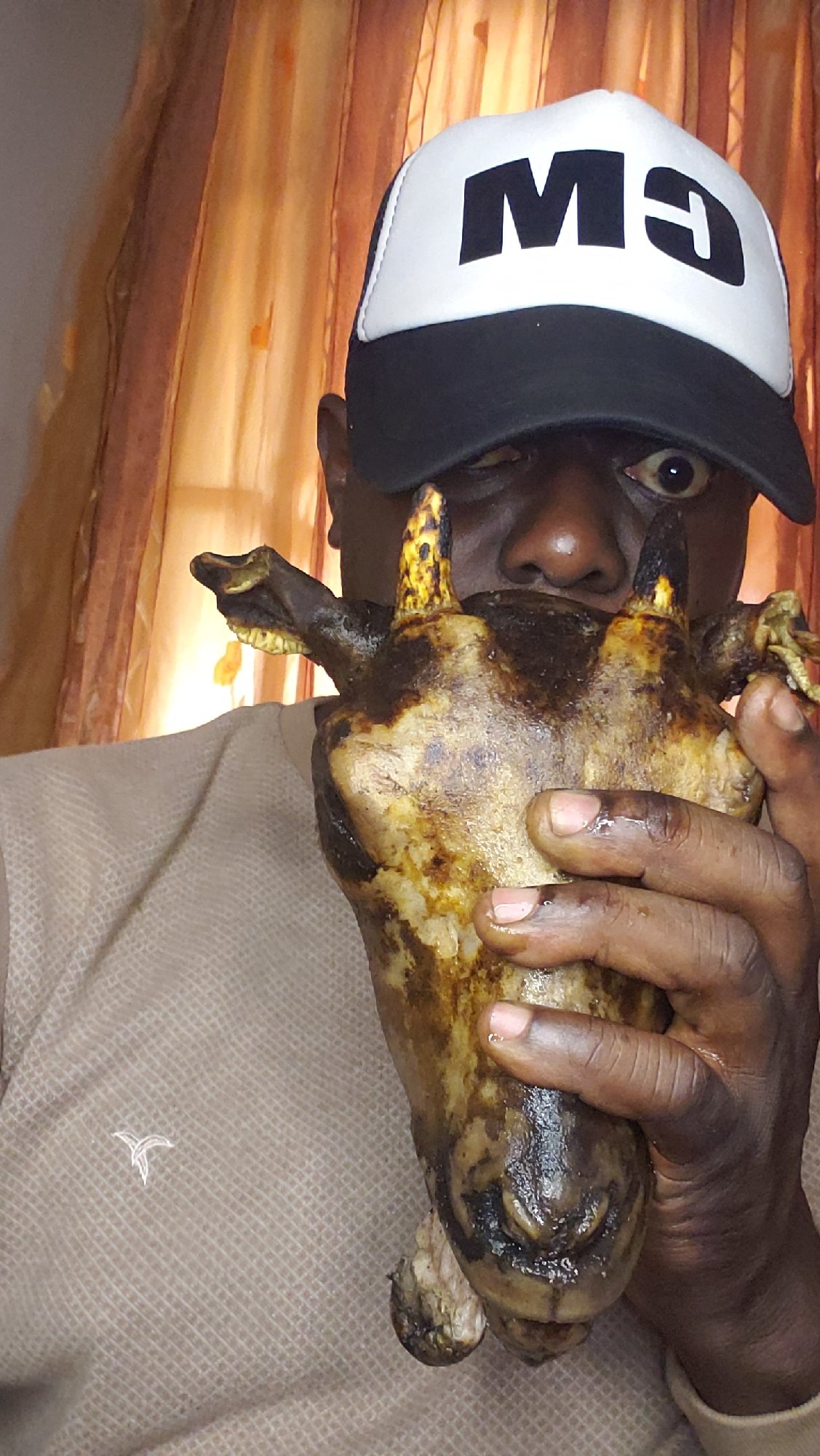 Birthday shoot in Nigeria featuring cooked goat heads and ring light poses