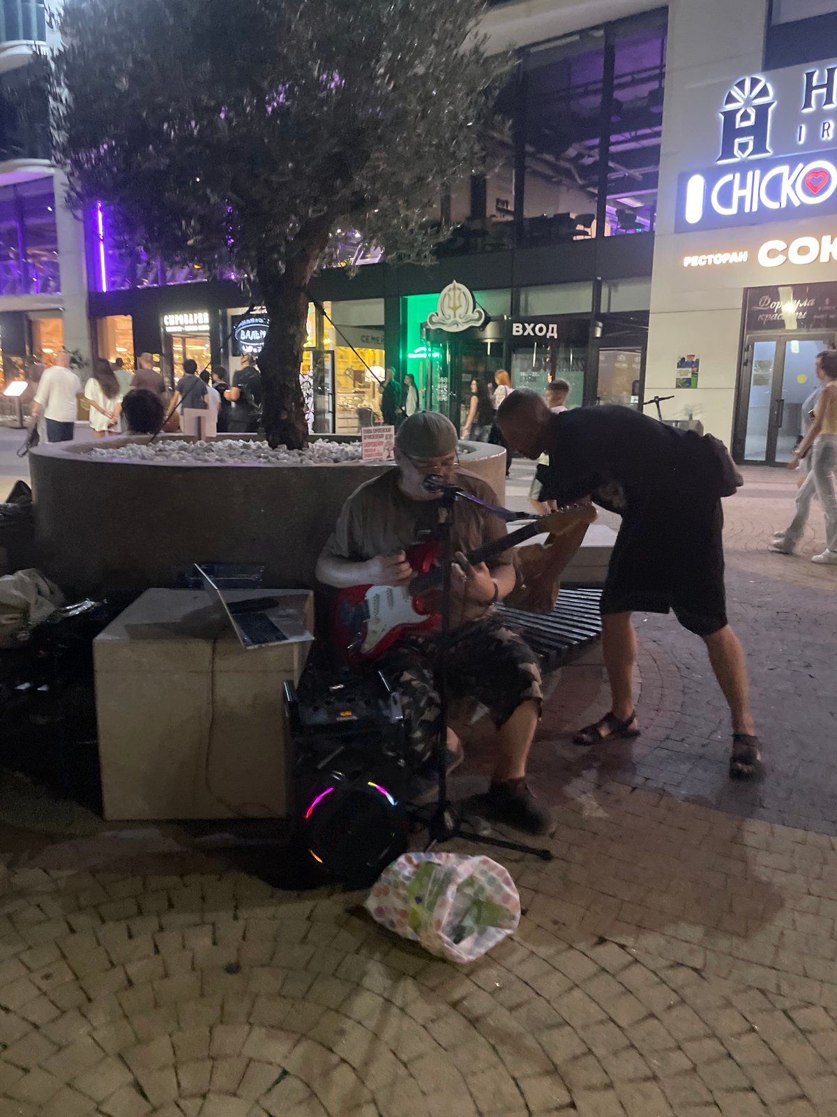 Late-night electric guitar session outside a Sadovyi building complex