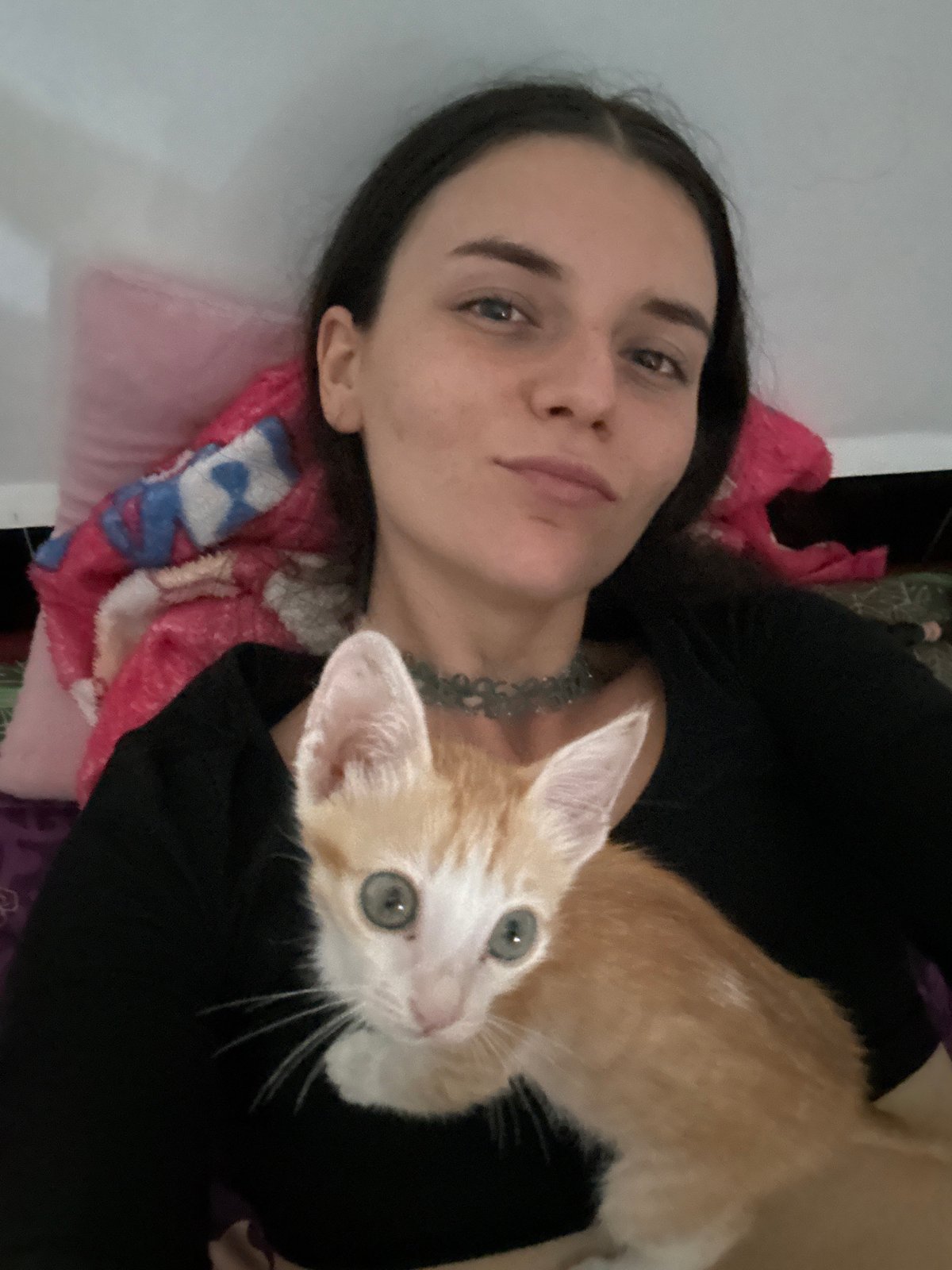 Woman and kitten rest together in Mũi Né home