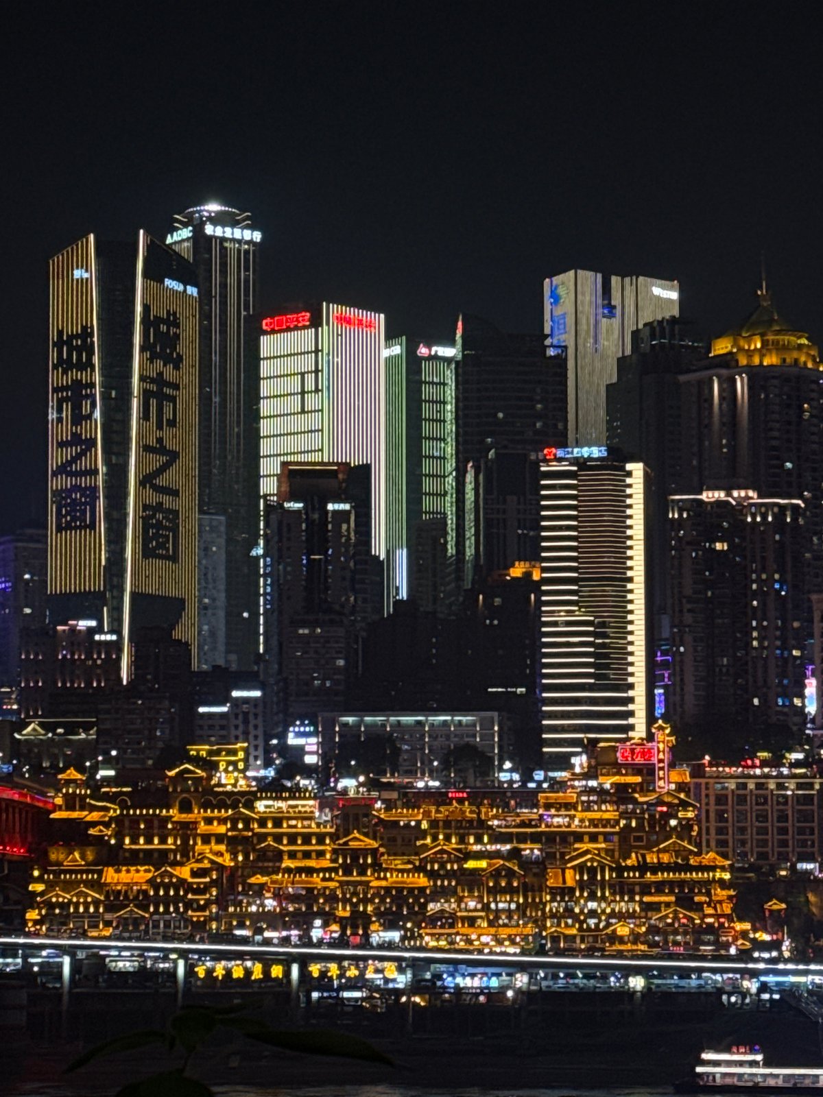 Chongqing's illuminated skyline and riverfront captured at night