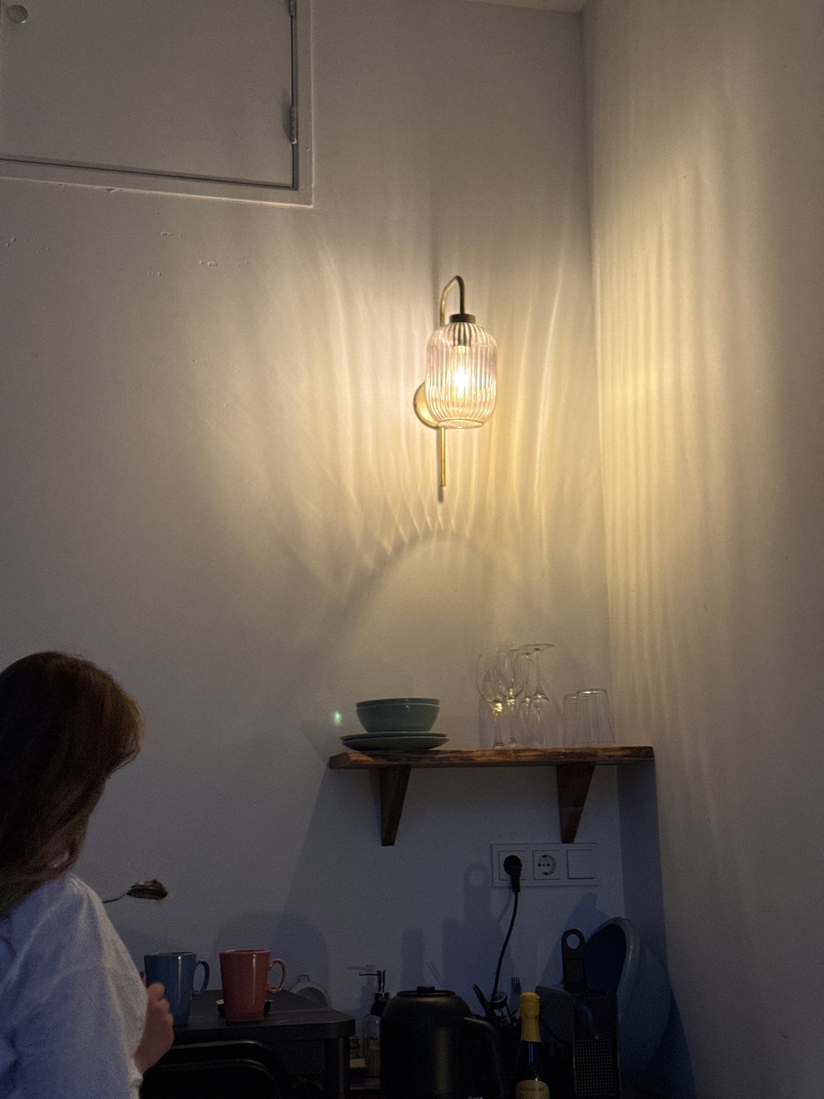 Person examines wall shelf in Amsterdam residential interior