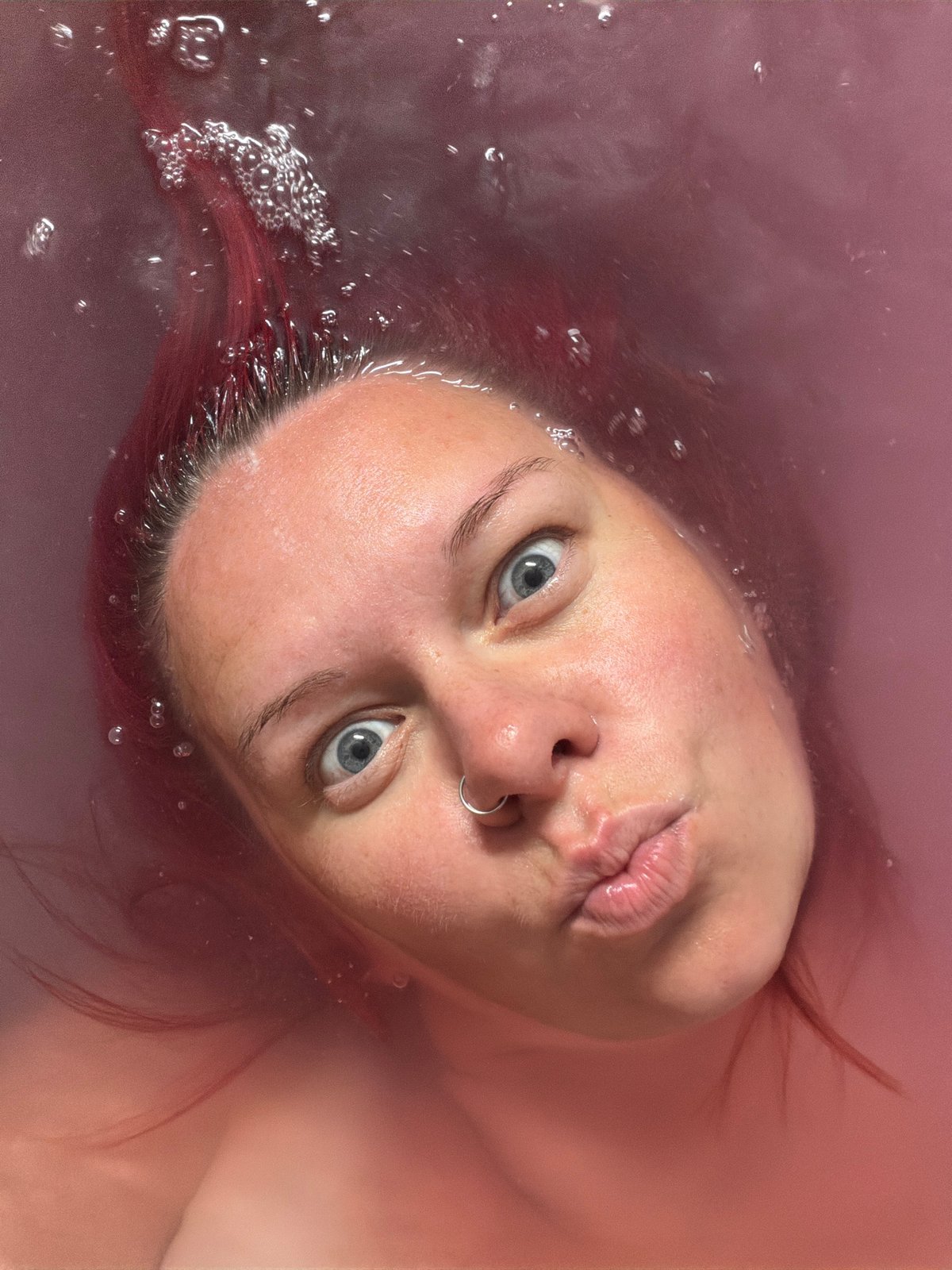 Playful bath selfie session in pink water, Chaikovsky