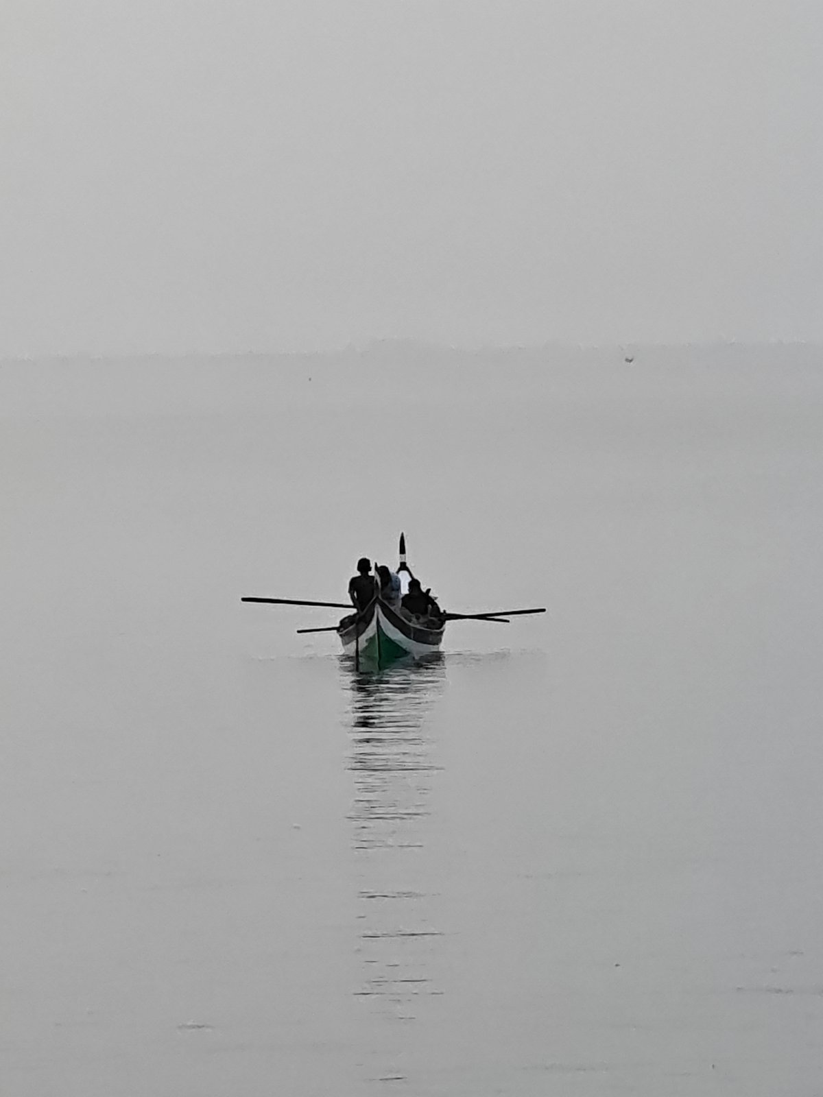 Traditional boats navigate calm waters near Lhokseumawe, Indonesia
