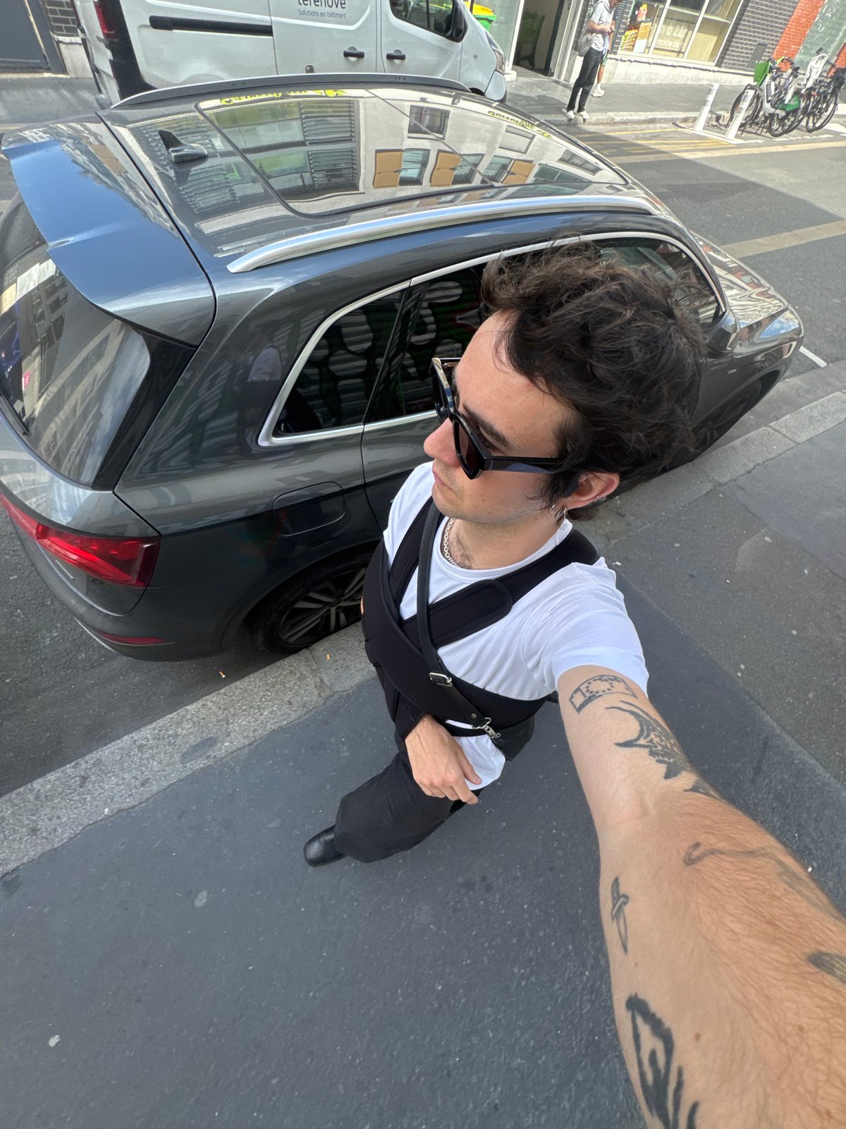 Man photographed beside car on Paris street