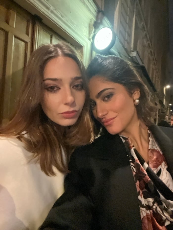 Two women enjoy evening dinner and drinks in Paris