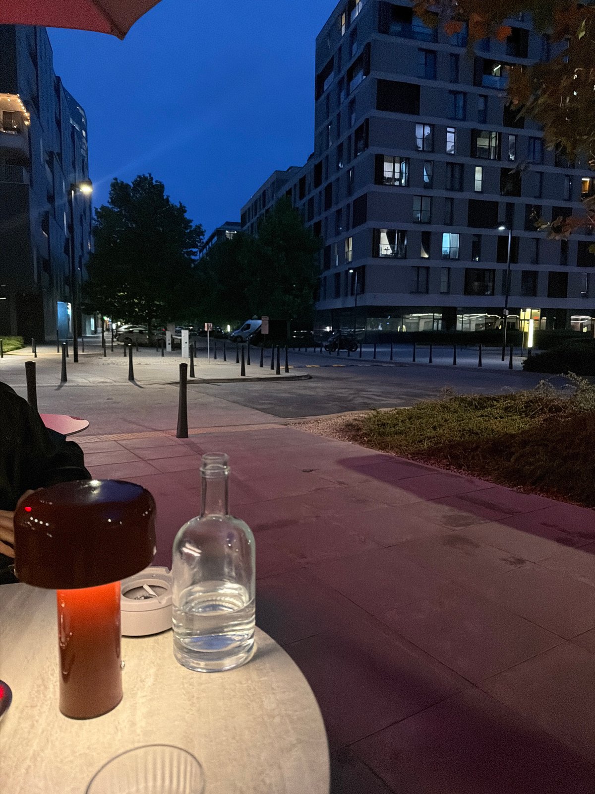 Woman takes evening selfies in urban outdoor setting