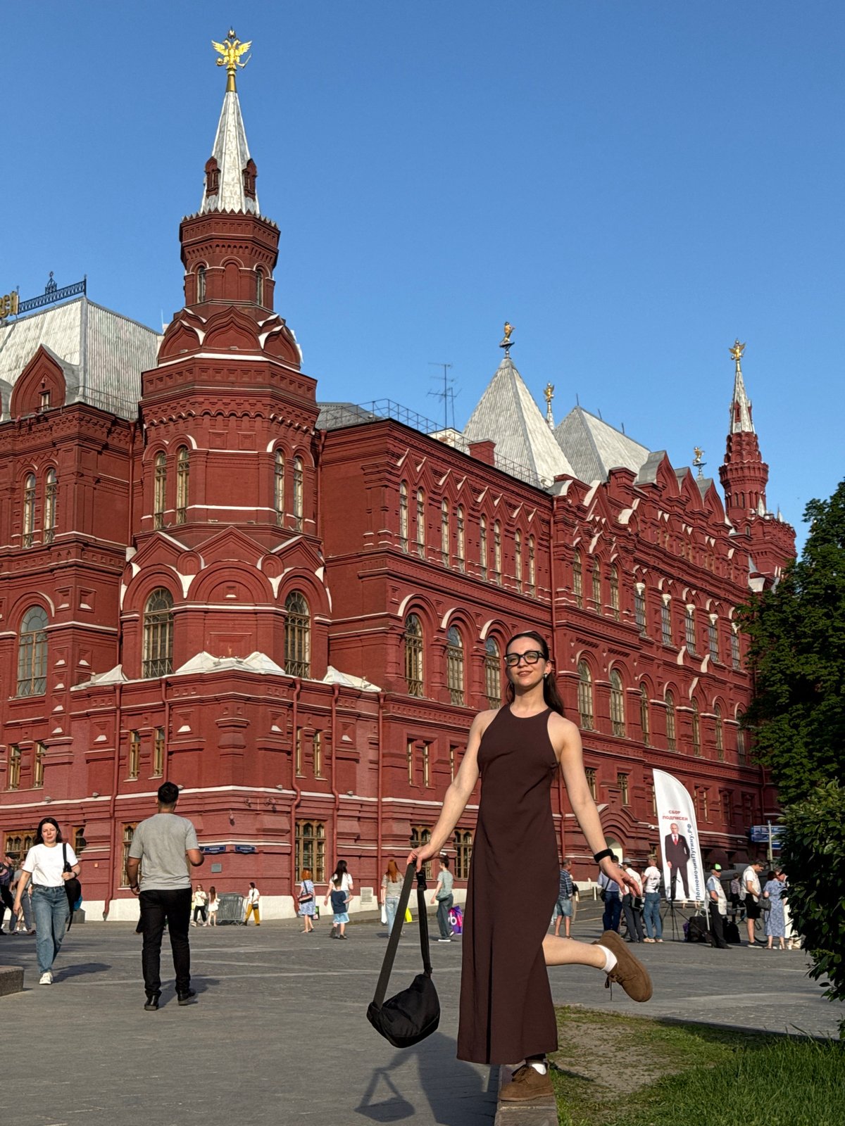 Woman poses with outstretched arms at Moscow Historical Museum