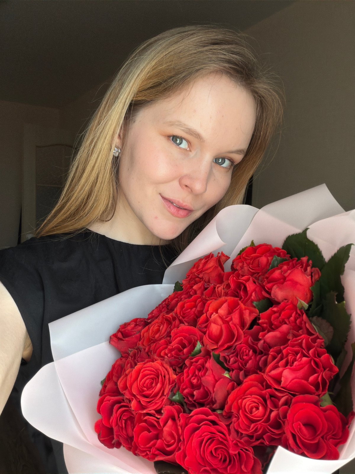 Woman displays red rose bouquet in Izhevsk, Russia