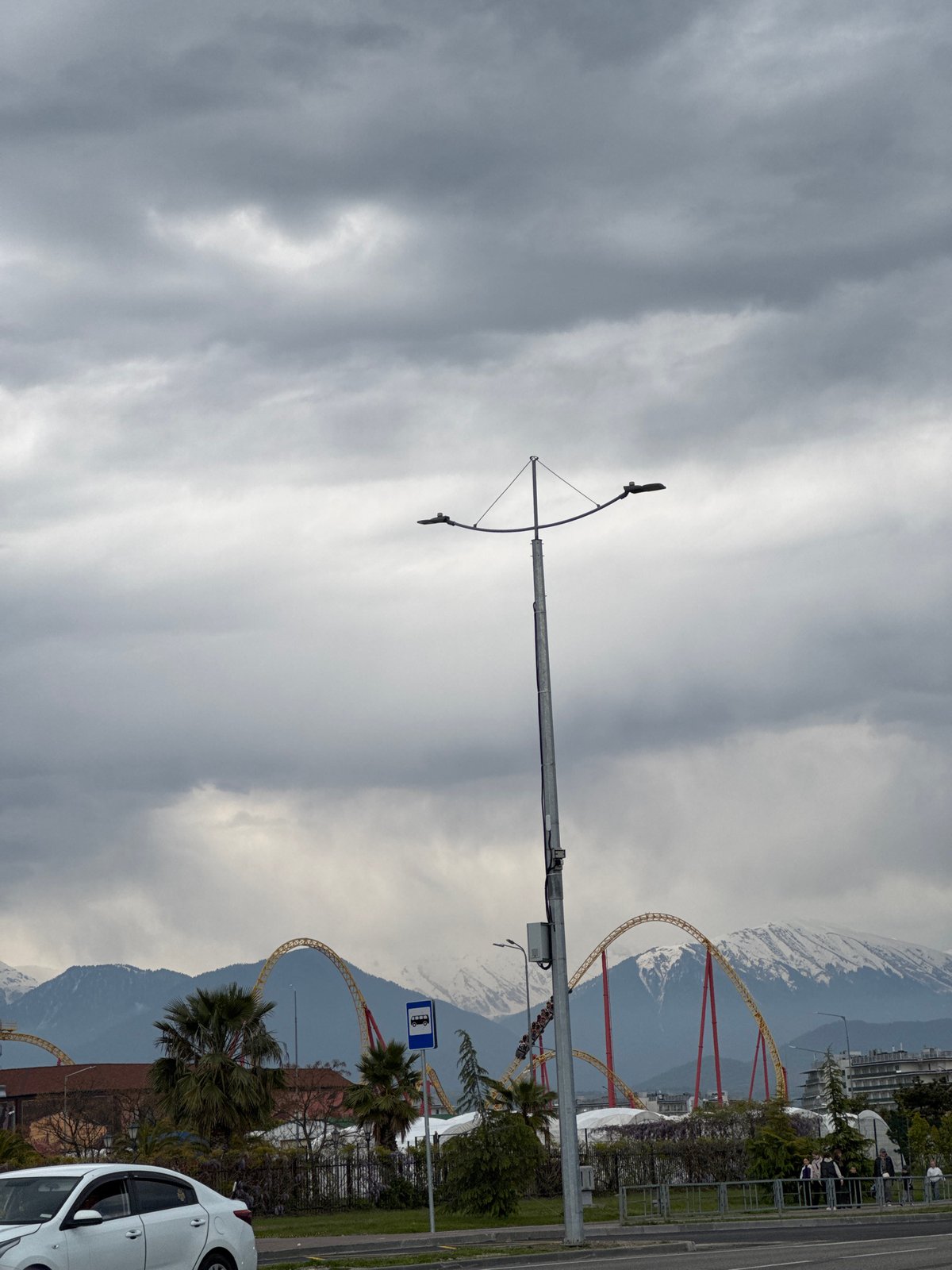 Overcast day captures street life near Sirius amusement park