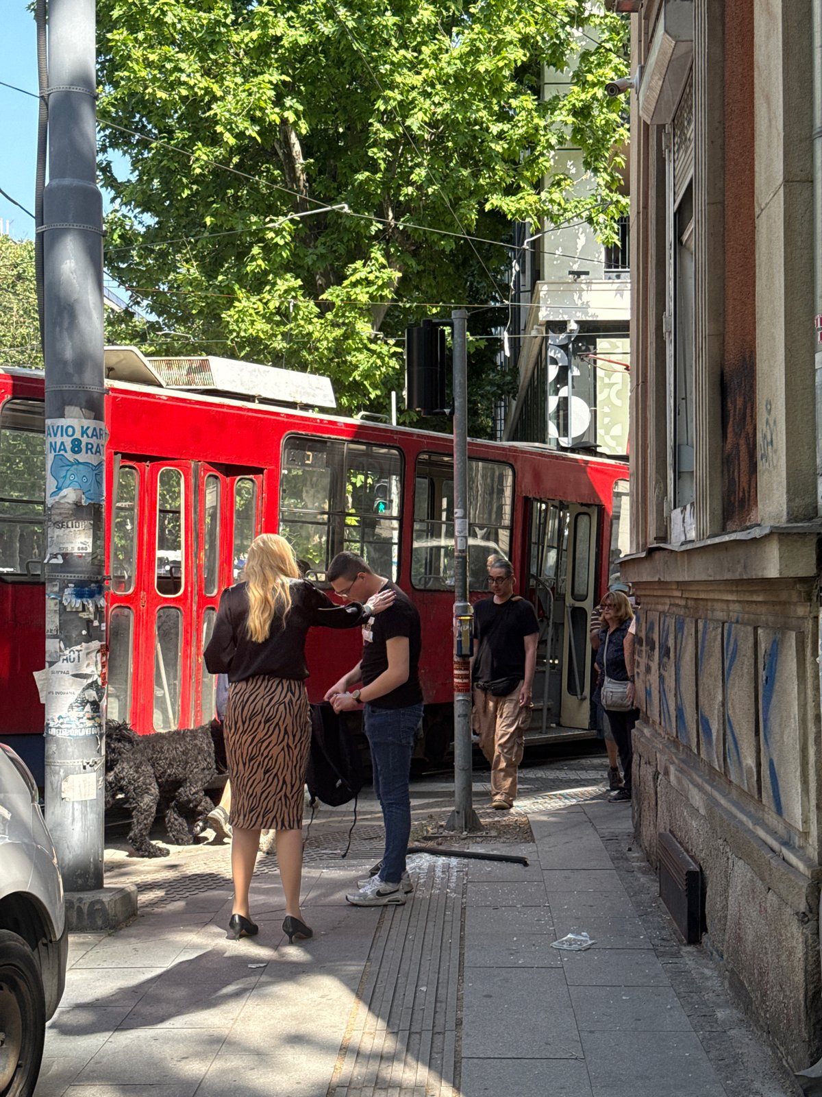Red tram crashes into Belgrade building, witnesses gather
