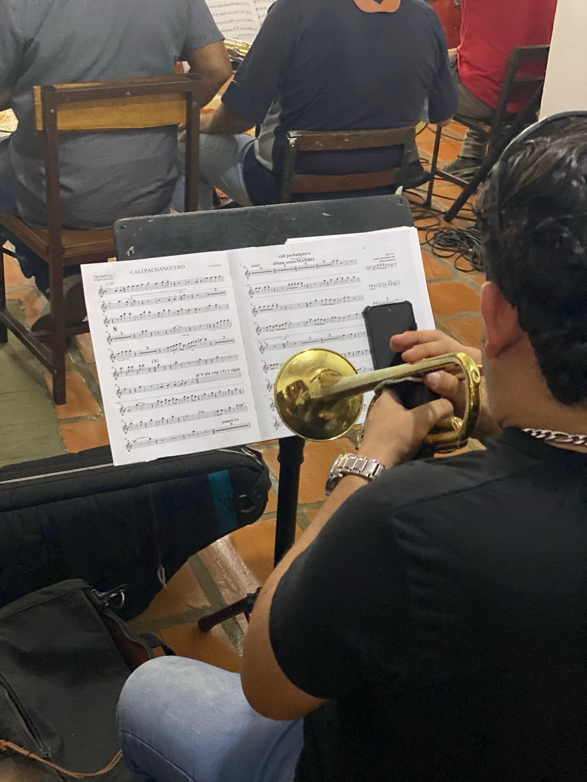 Musicians rehearse brass instruments indoors in Tinaquillo, Venezuela