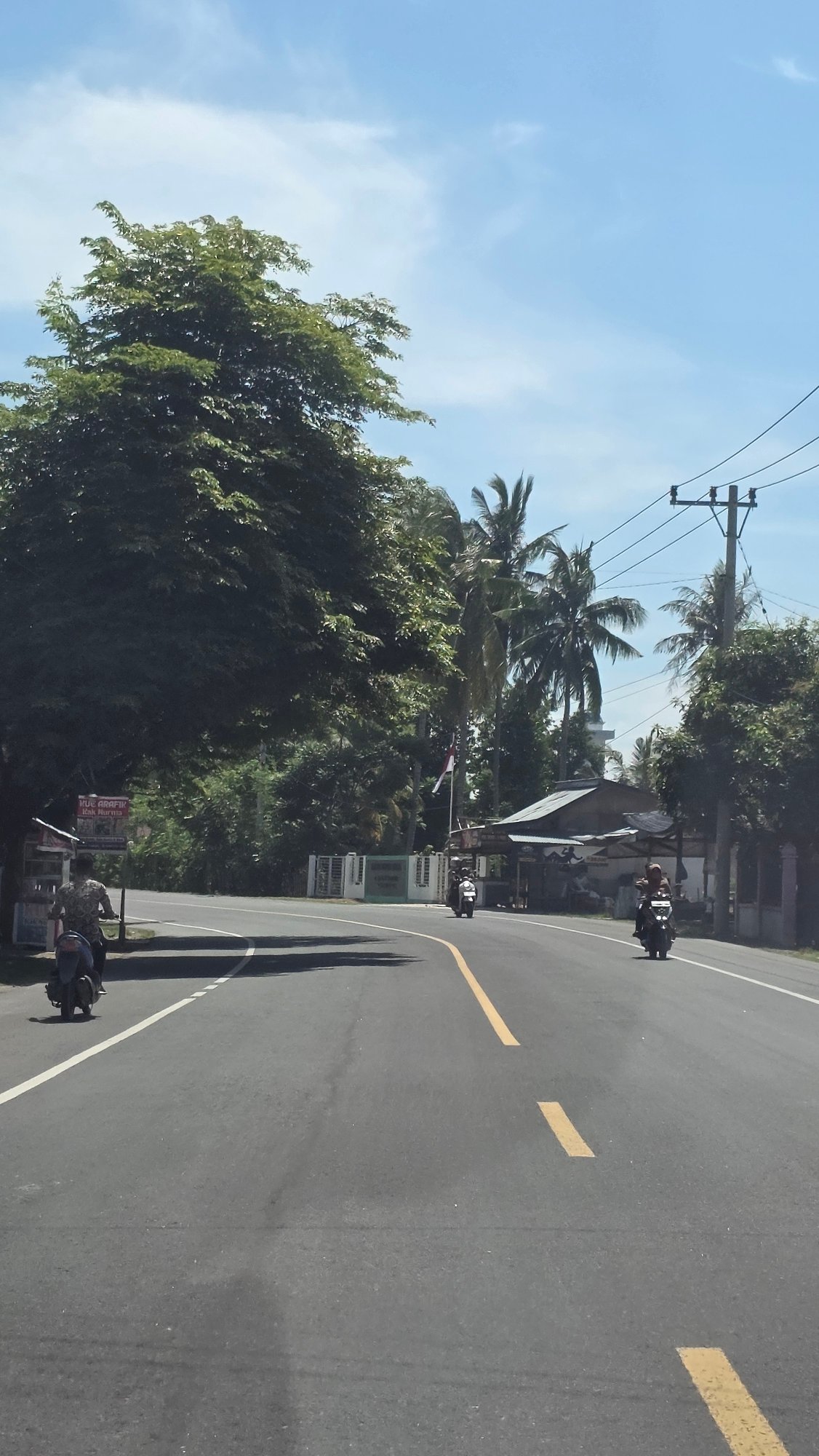 Motorcycles spotted on curved road in Paya Tringgadeng, Indonesia