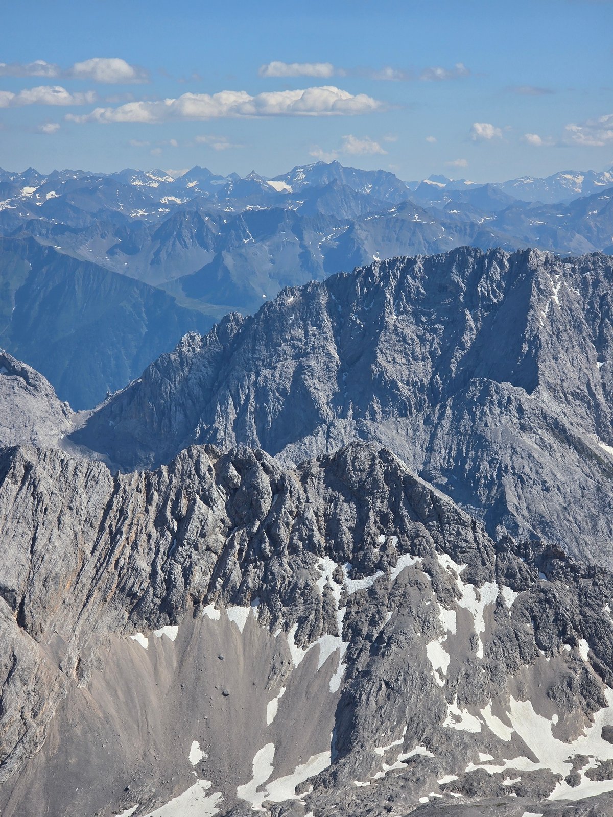 Zugspitze area: alpine peaks, Eibsee, and a glider in flight